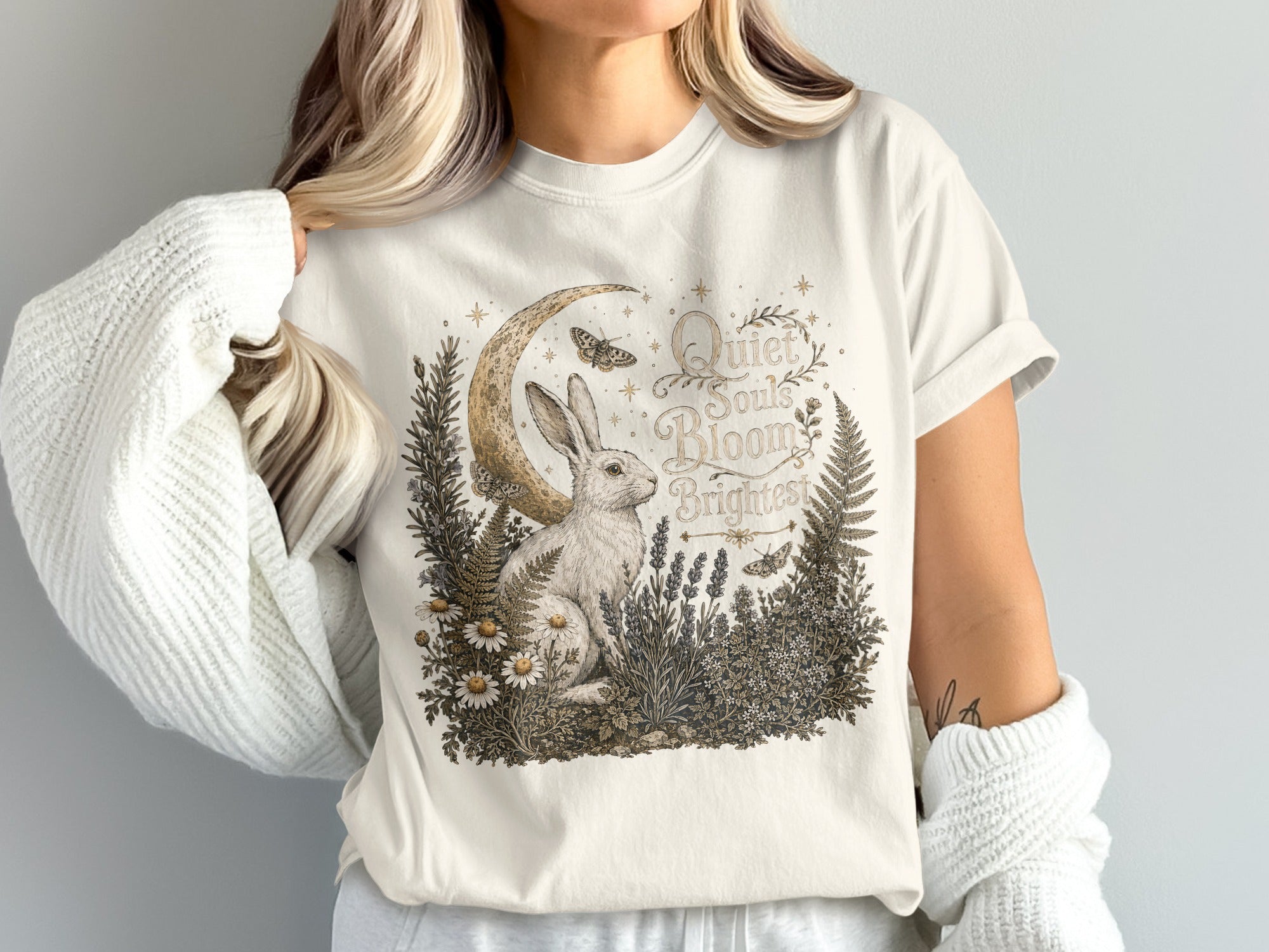 White t-shirt graphic of rabbit, moon, flowers and text "Quiet Souls Bloom Brightest".