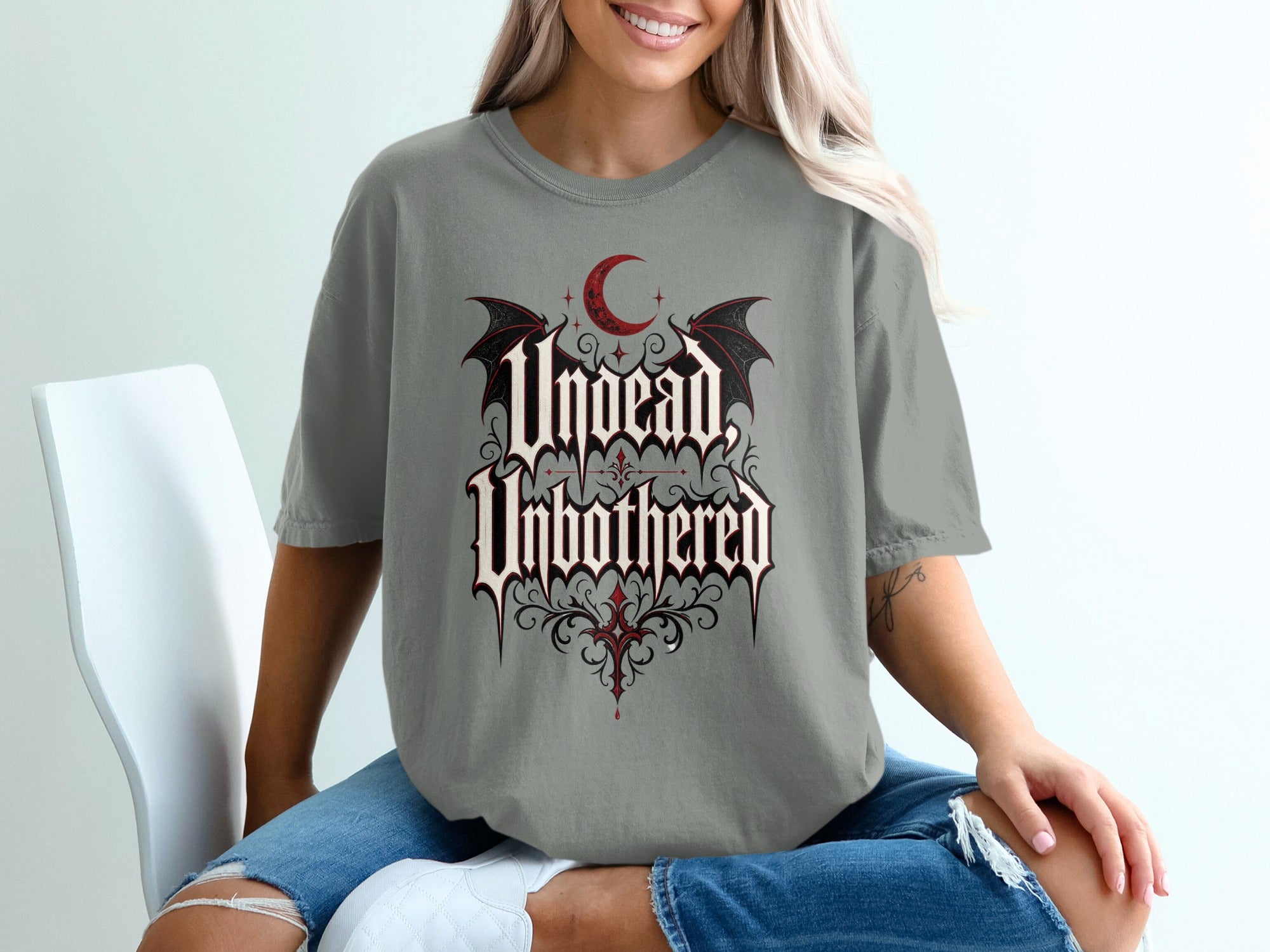 Grey t-shirt with "Undead, Unbothered" gothic text, crescent moon, and bat wings.
