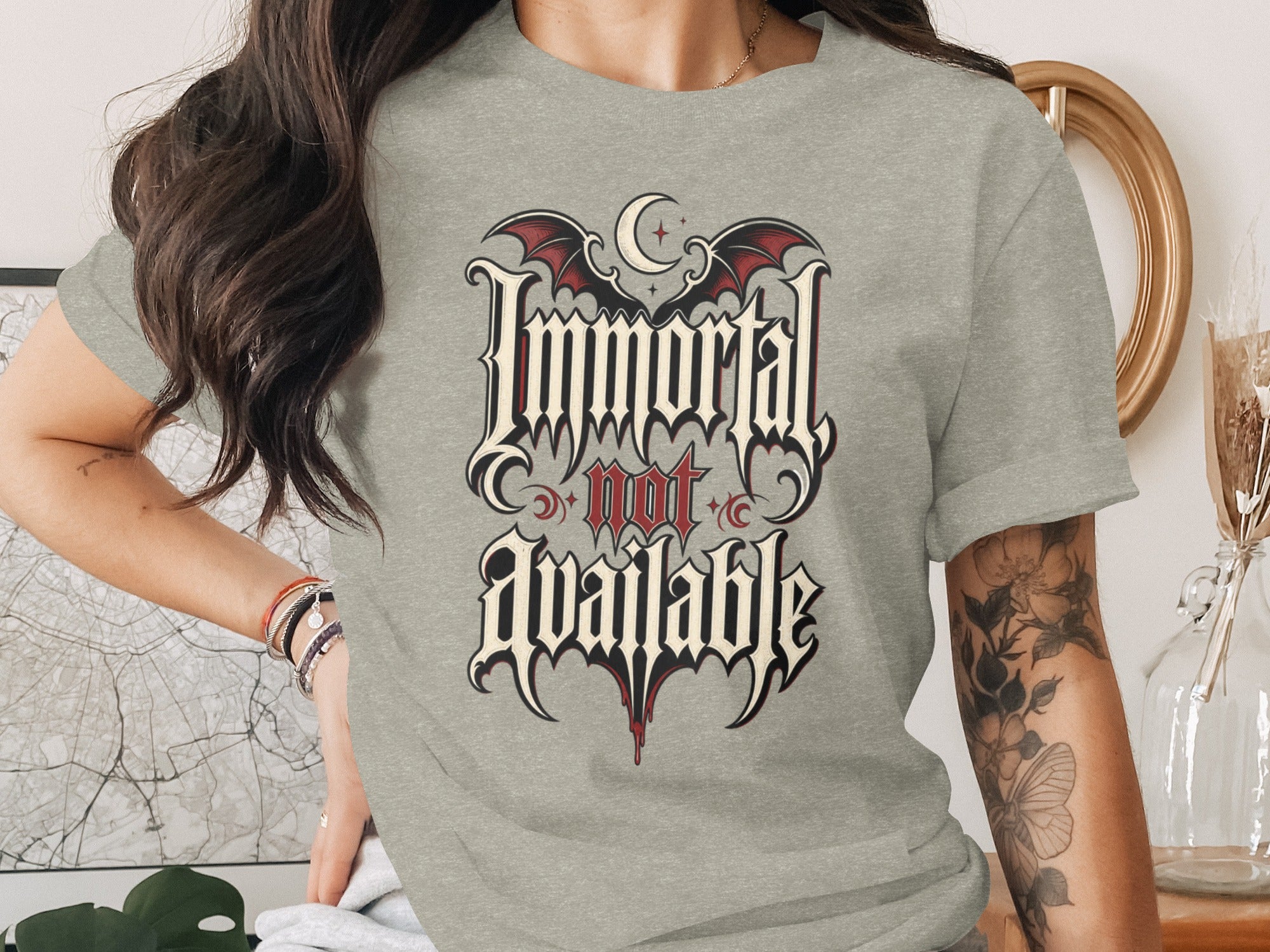 Grey t-shirt with "Immortal not available" text and gothic bat wings.