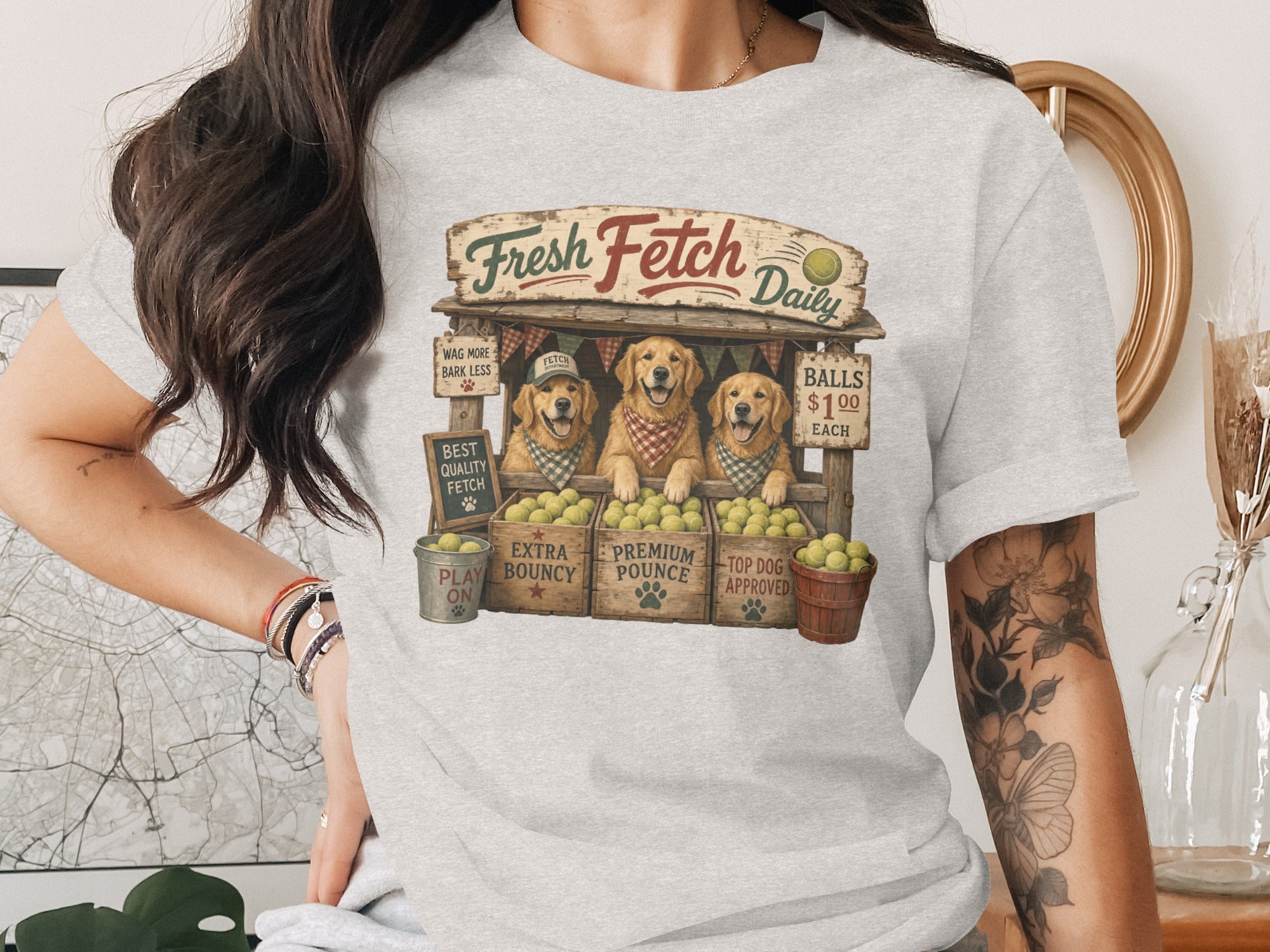 Three golden retrievers at a stand called "Fresh Fetch Daily" selling tennis balls.