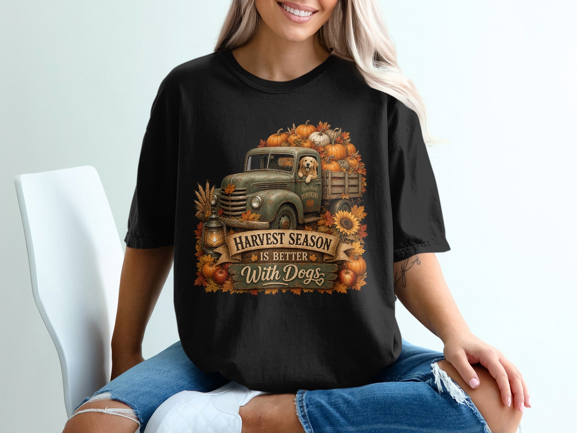 Black t-shirt graphic with vintage truck, pumpkins, dog, and text "Harvest Season Is Better With Dogs."