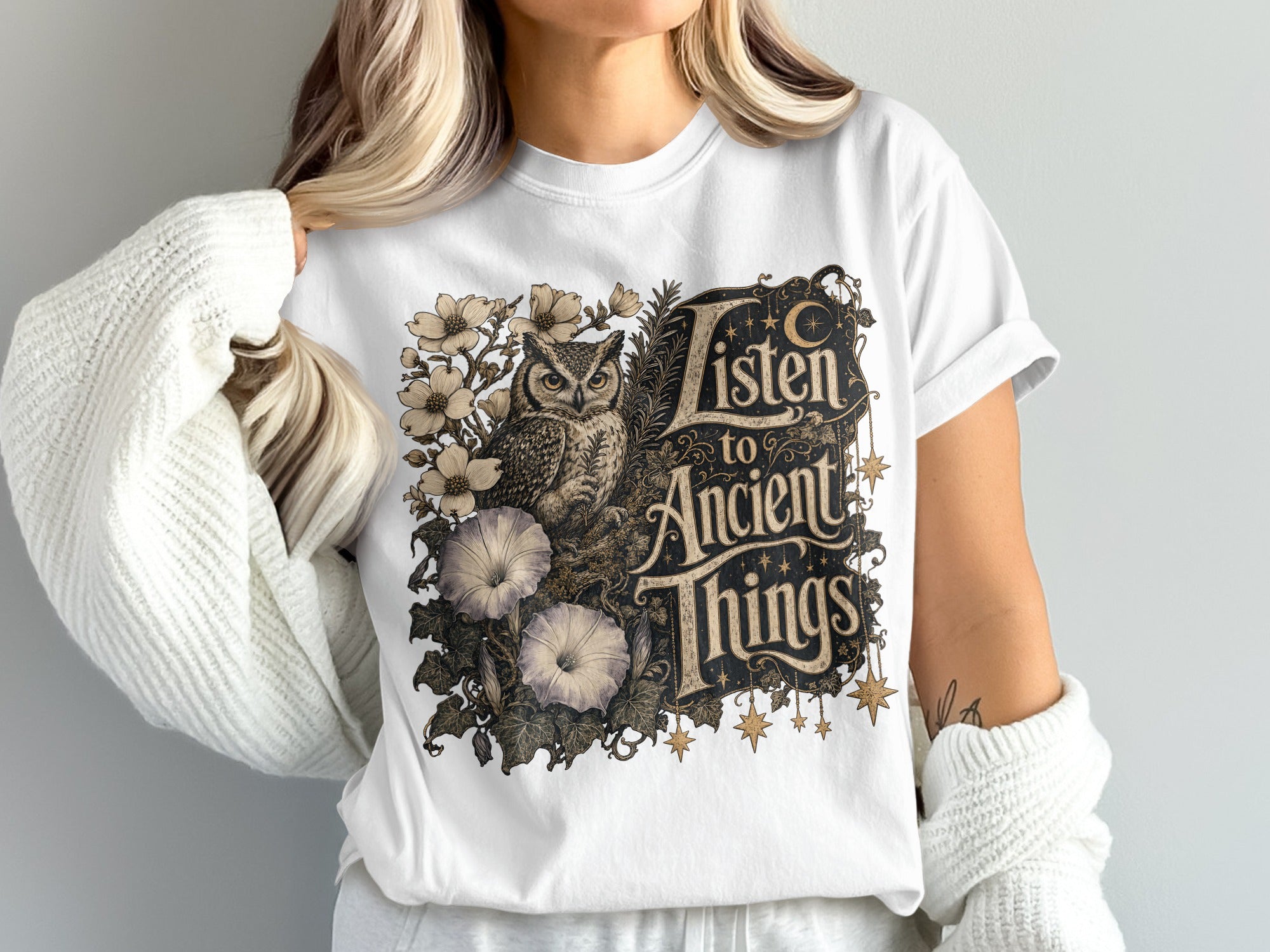 T-shirt with owl, flowers, and text "Listen to Ancient Things".