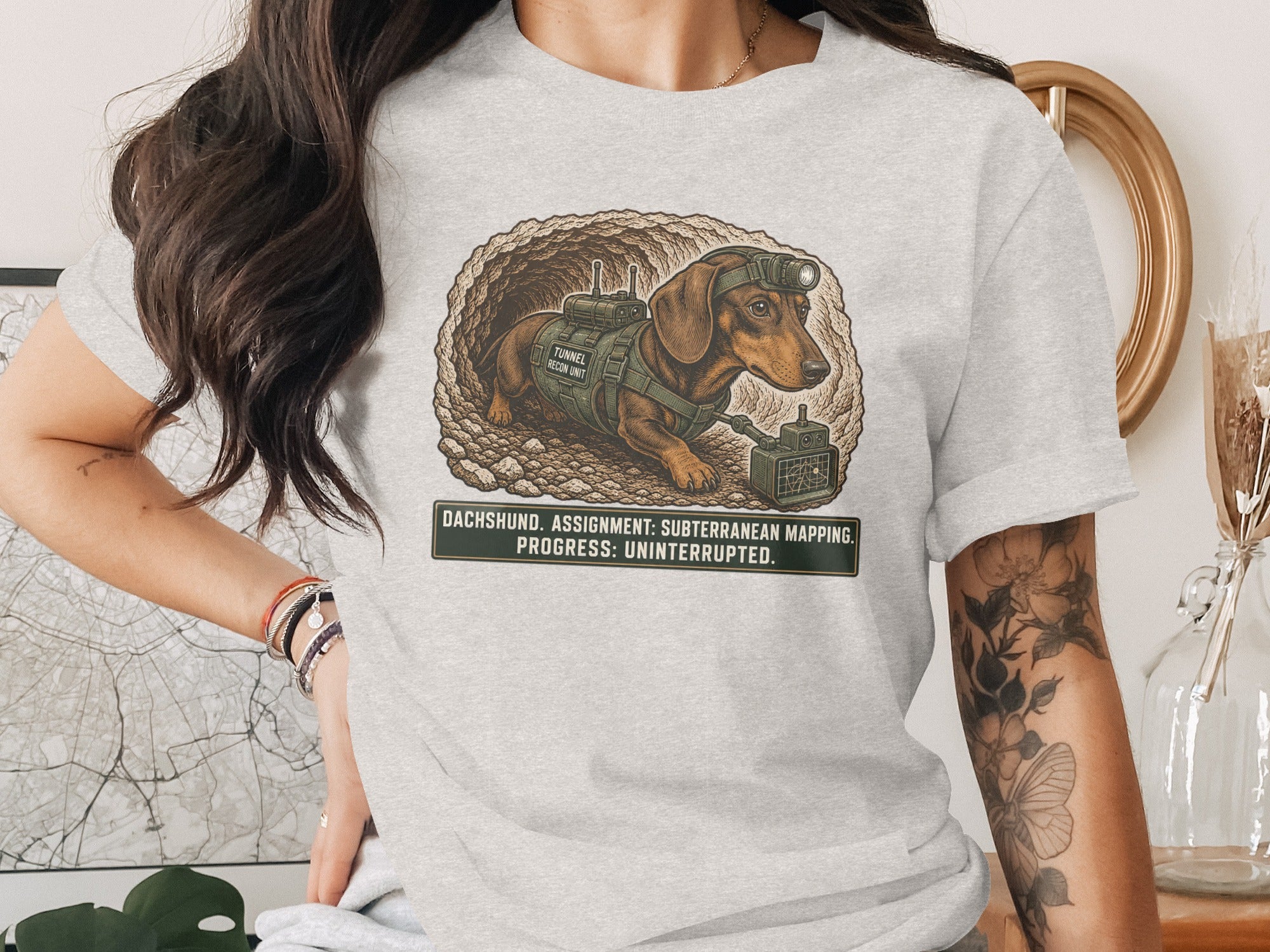 Dachshund in tactical gear in tunnel, with text: Dachshund. Assignment: Subterranean Mapping. Progress: Uninterrupted.