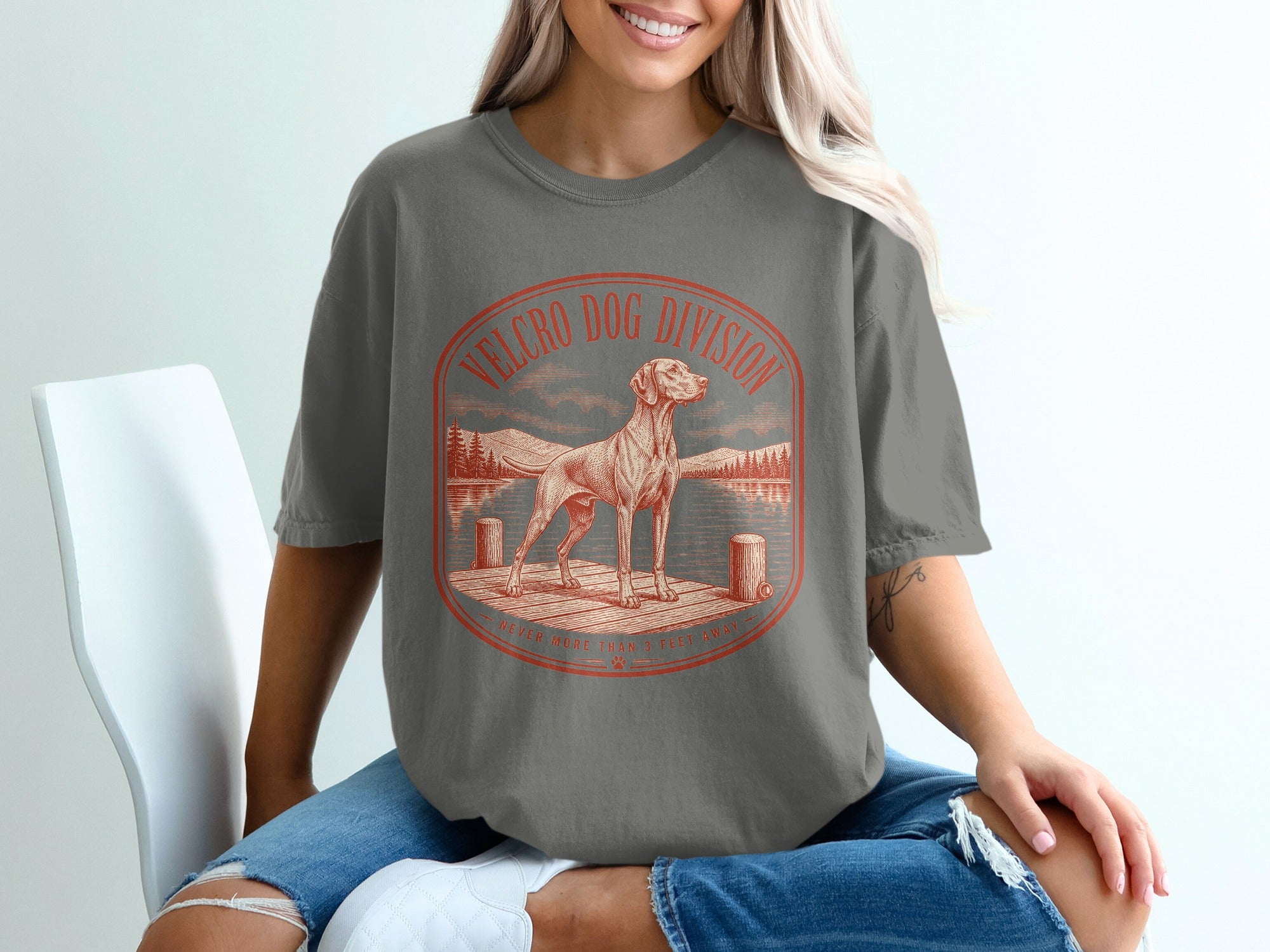 T-shirt featuring a dog on a dock with text "Velcro Dog Division".