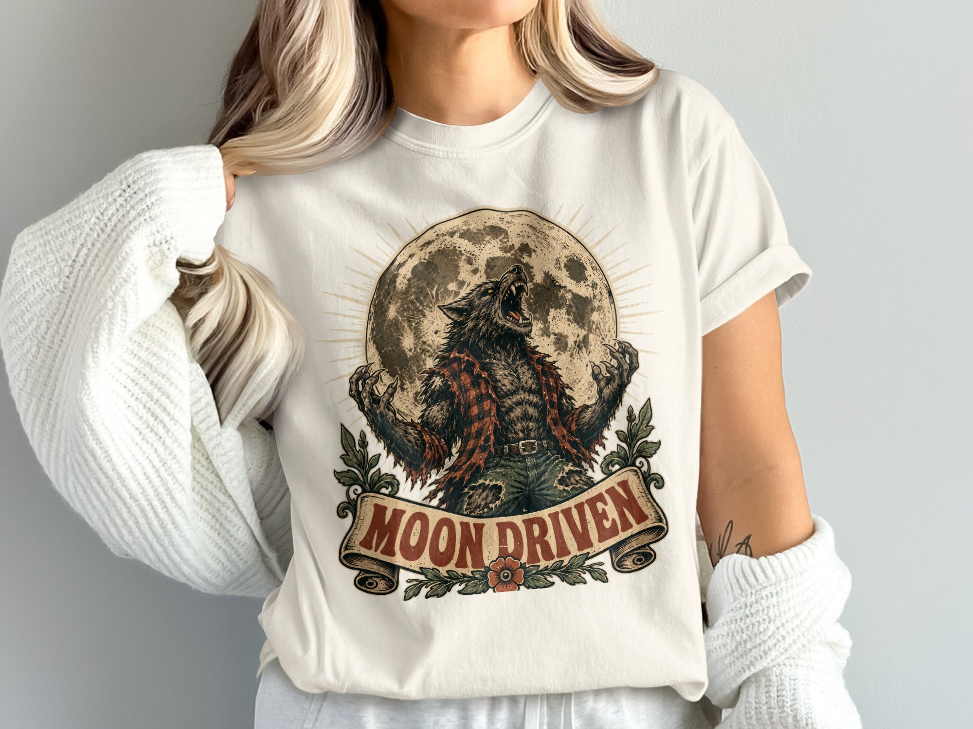 Werewolf howling at the moon graphic with "Moon Driven" text on a t-shirt.