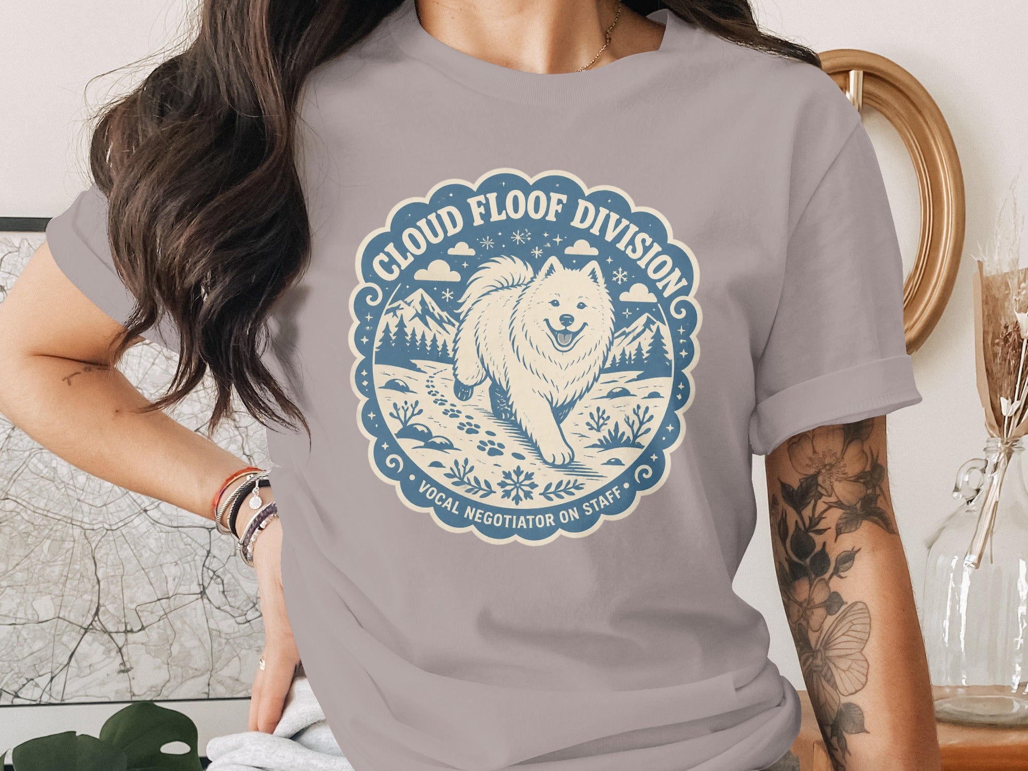 T-shirt design with a fluffy white dog walking in a snowy landscape, text "Cloud Floof Division Vocal Negotiator on Staff".