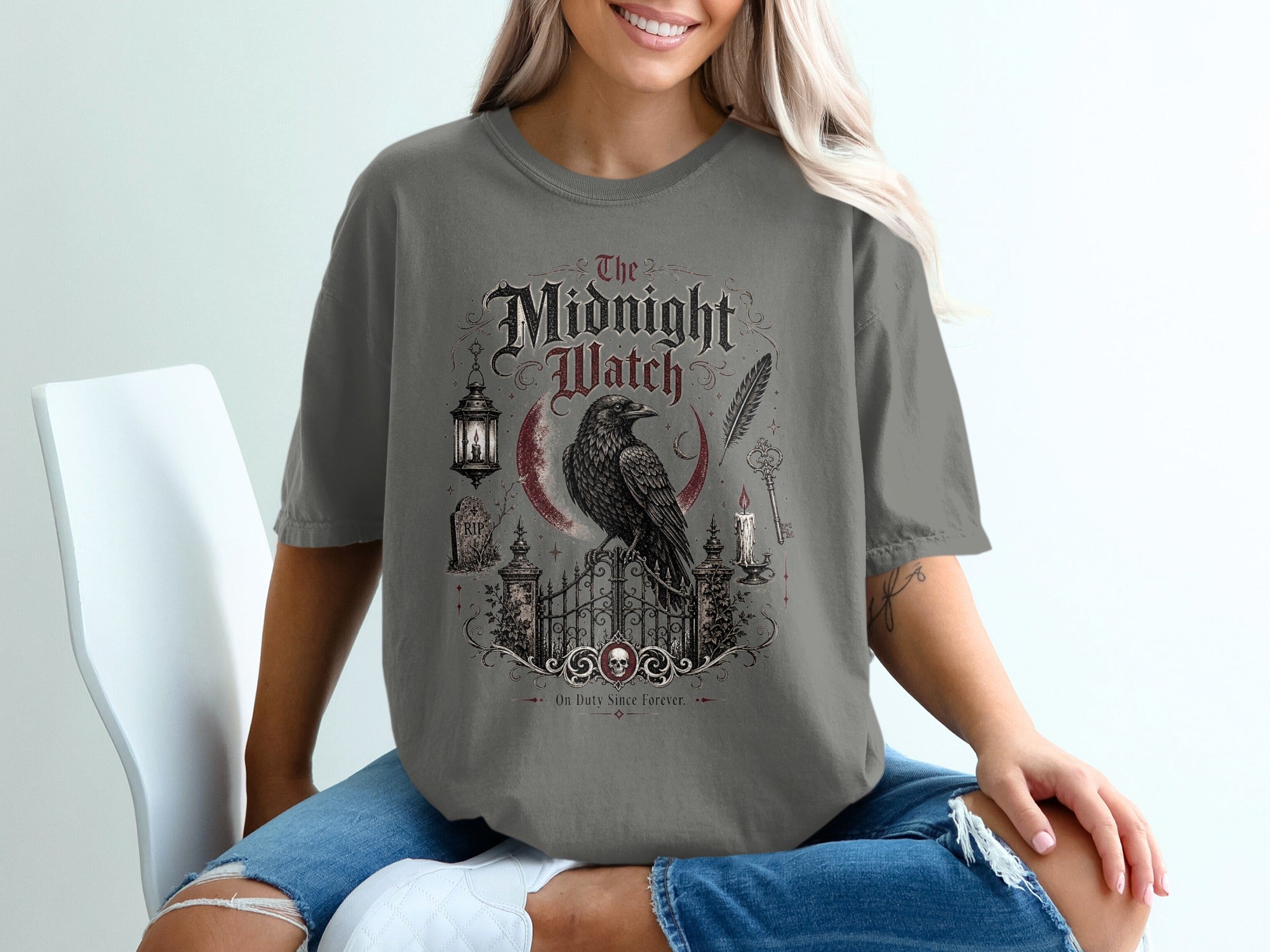 The Midnight Watch t-shirt features a raven on a gate with text and gothic elements.