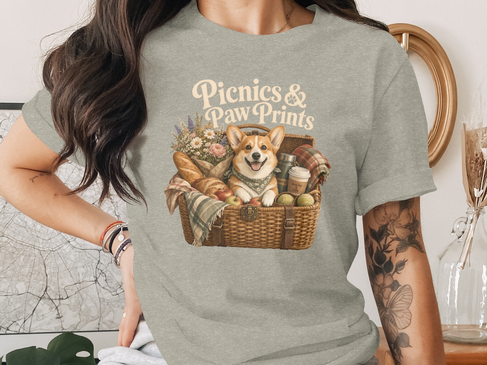 Corgi in picnic basket with text "Picnics & Paw Prints".