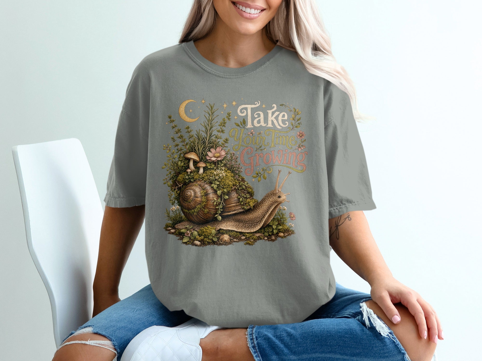 Snail with mossy shell and plants, reads "Take Your Time Growing".