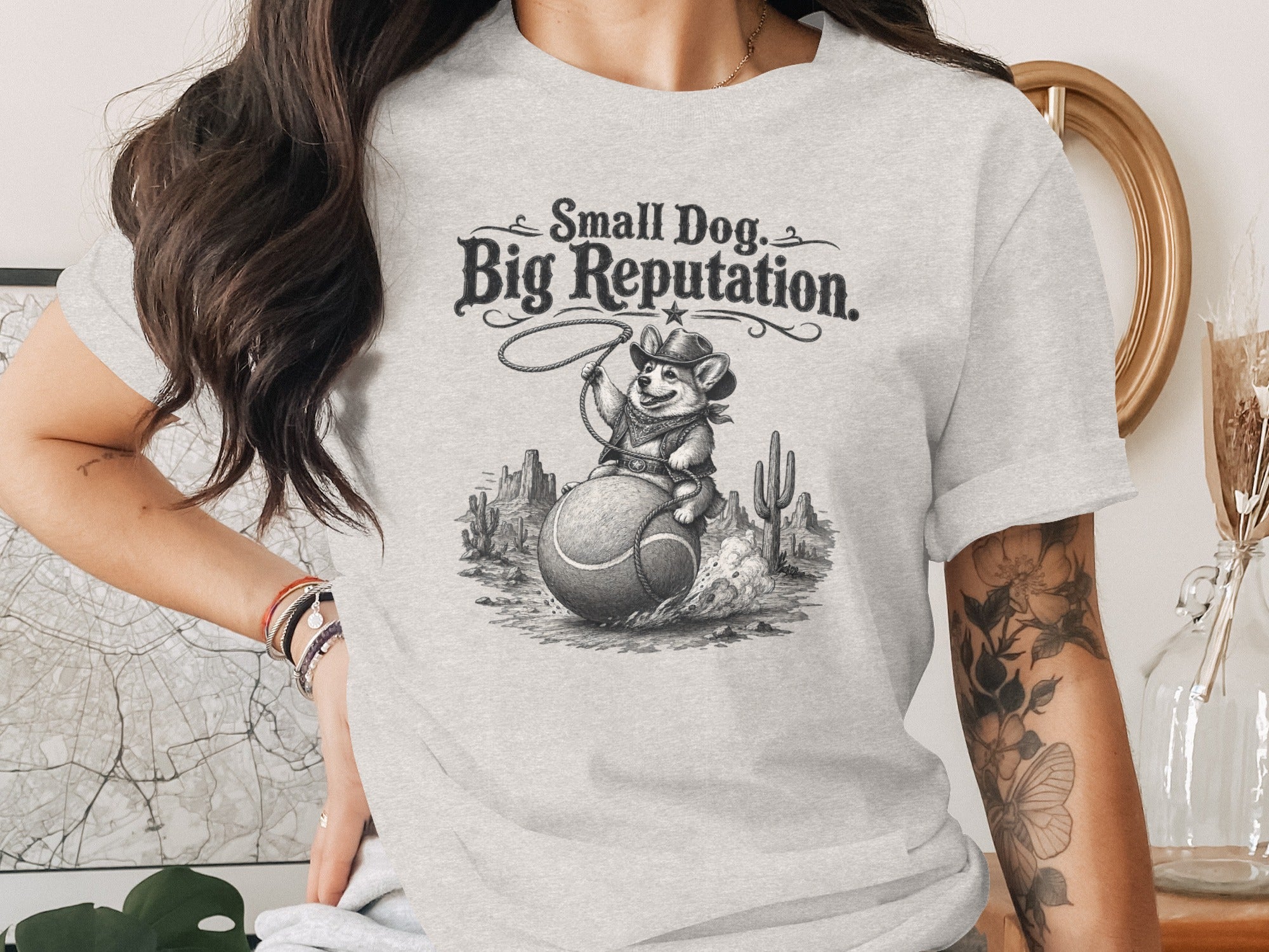 Corgi in cowboy hat riding tennis ball with "Small Dog, Big Reputation" text.