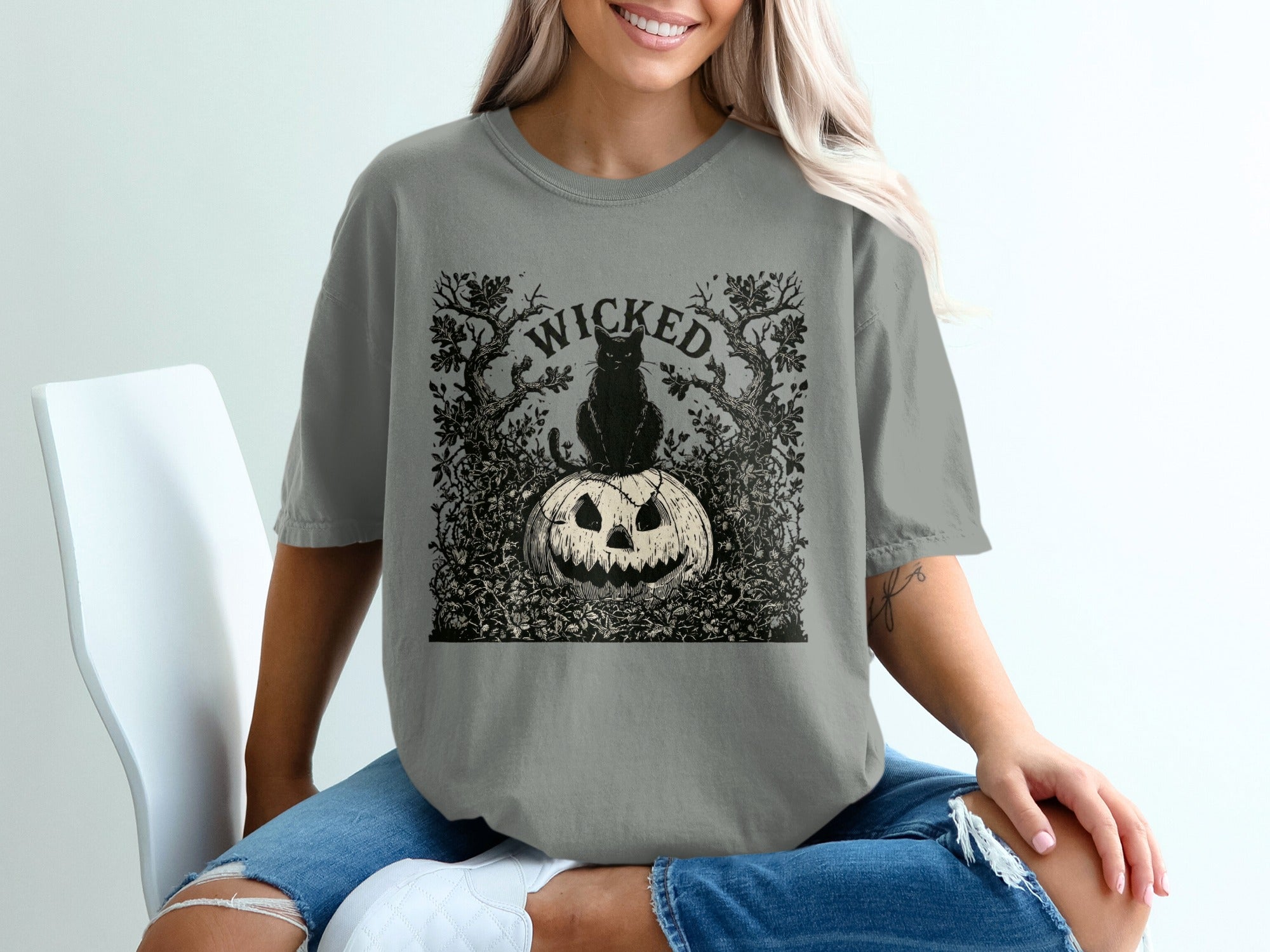 Black cat sits on a carved pumpkin under the word "WICKED" within a forest illustration.