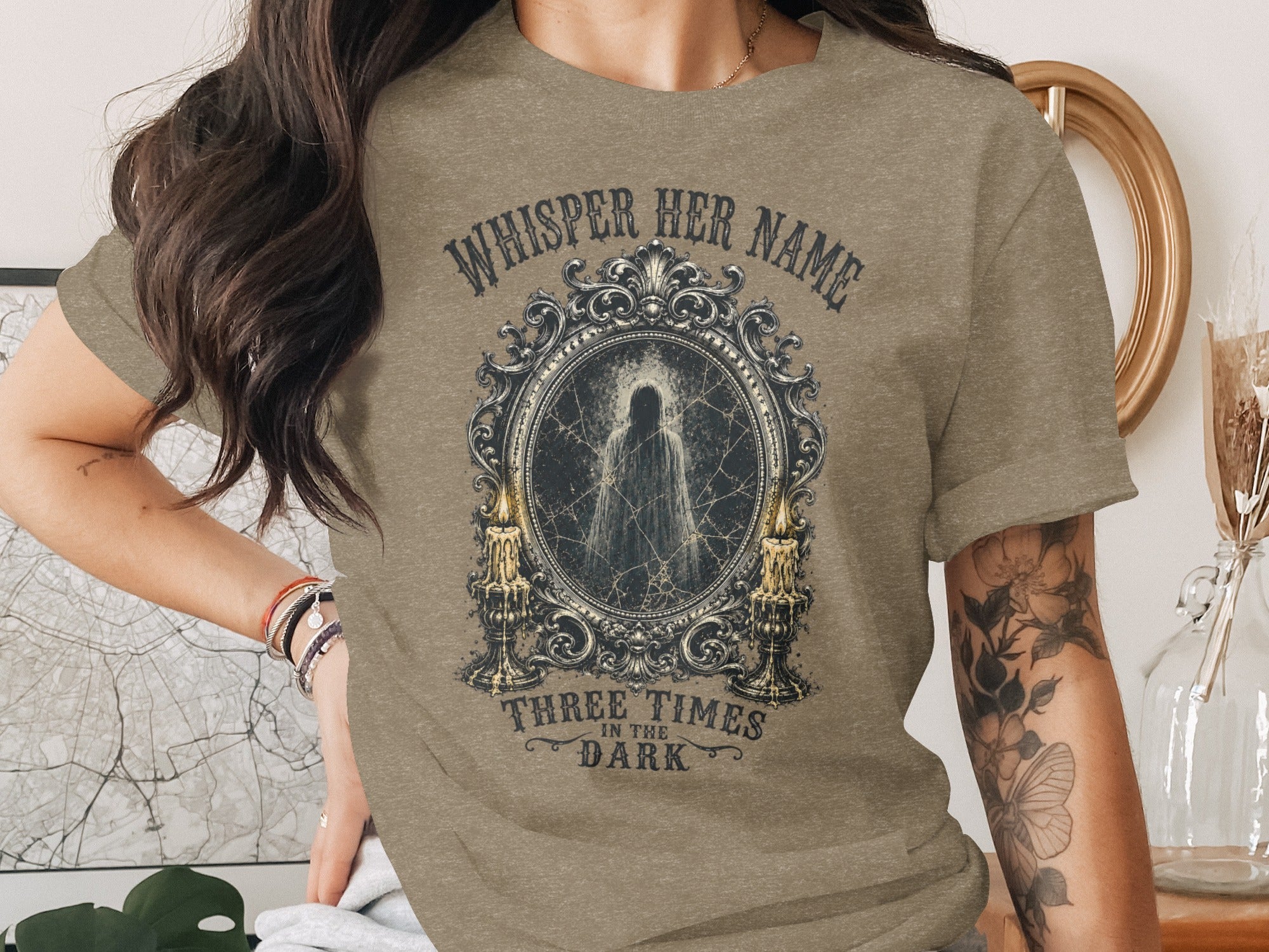 T-shirt with graphic featuring a ghostly figure in an ornate frame.