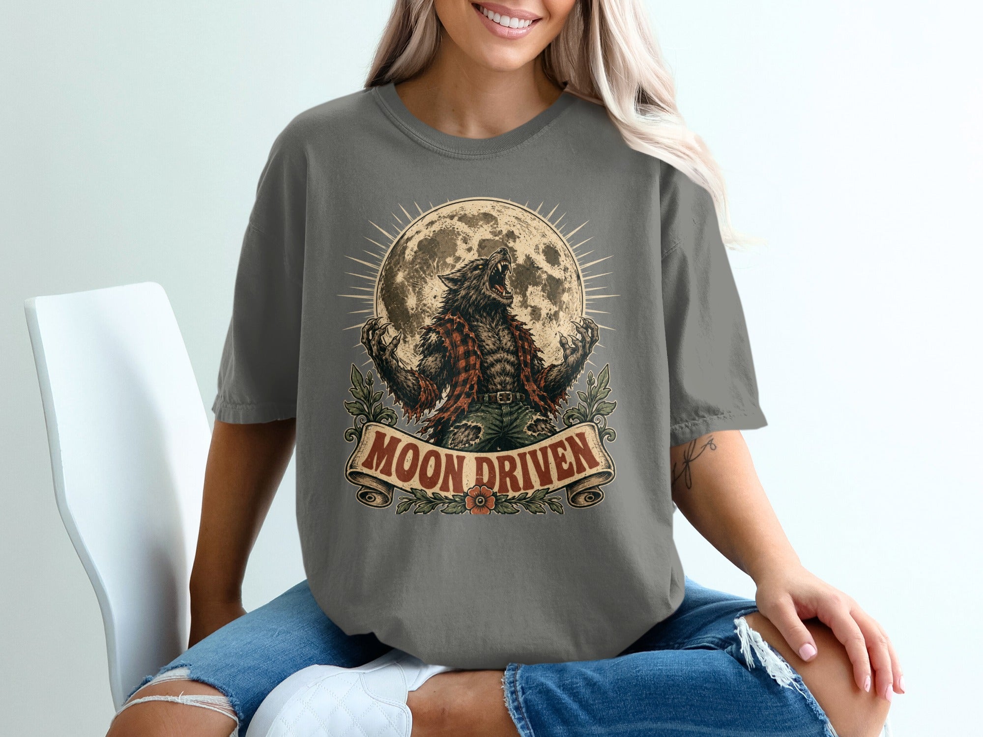 Werewolf howling at the moon with "MOON DRIVEN" text on a t-shirt.
