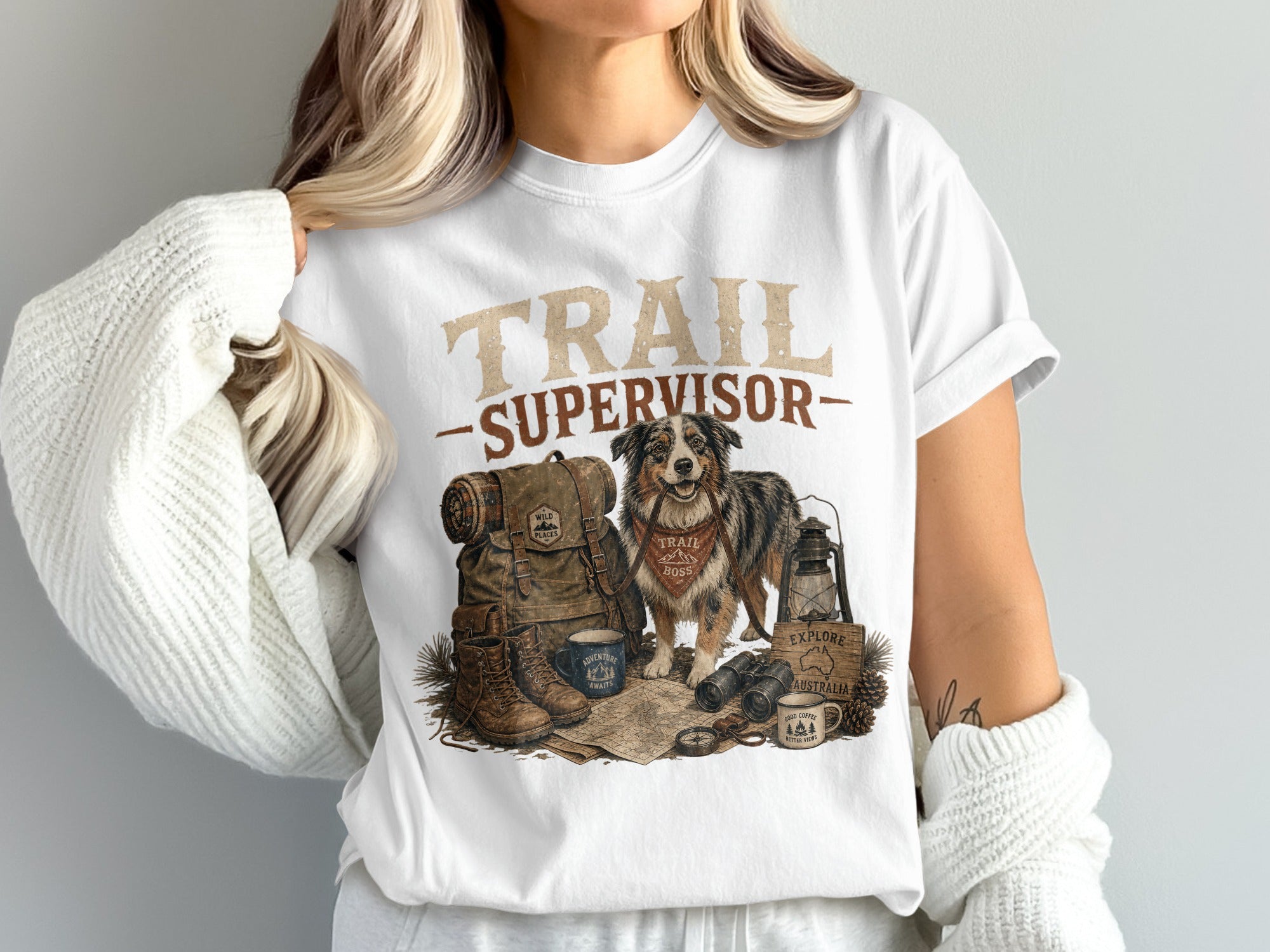 T-shirt graphic with dog, backpack, boots, compass, binoculars, and text "TRAIL SUPERVISOR"