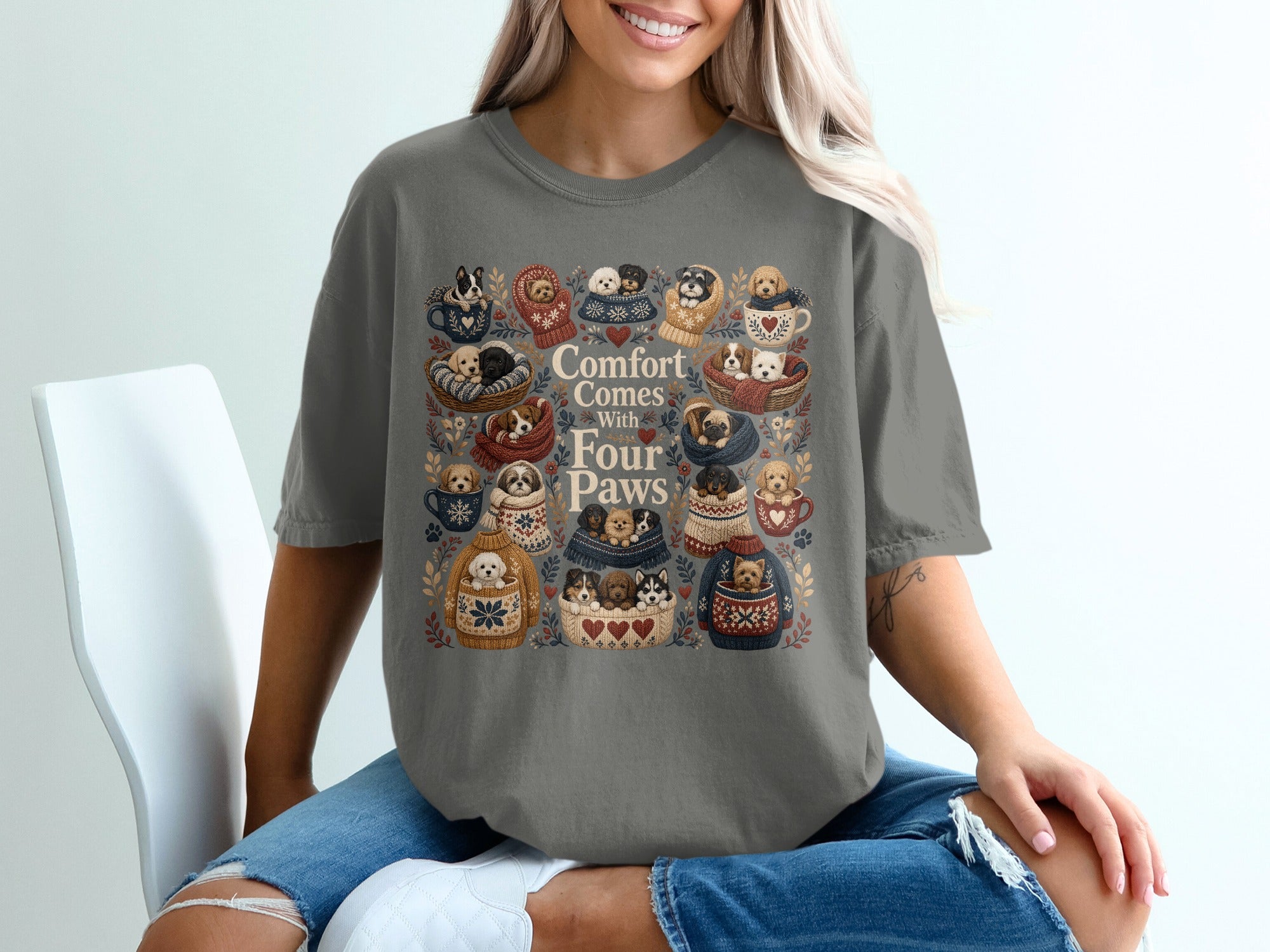 Grey shirt with "Comfort Comes With Four Paws" and illustrations of puppies in cozy settings.