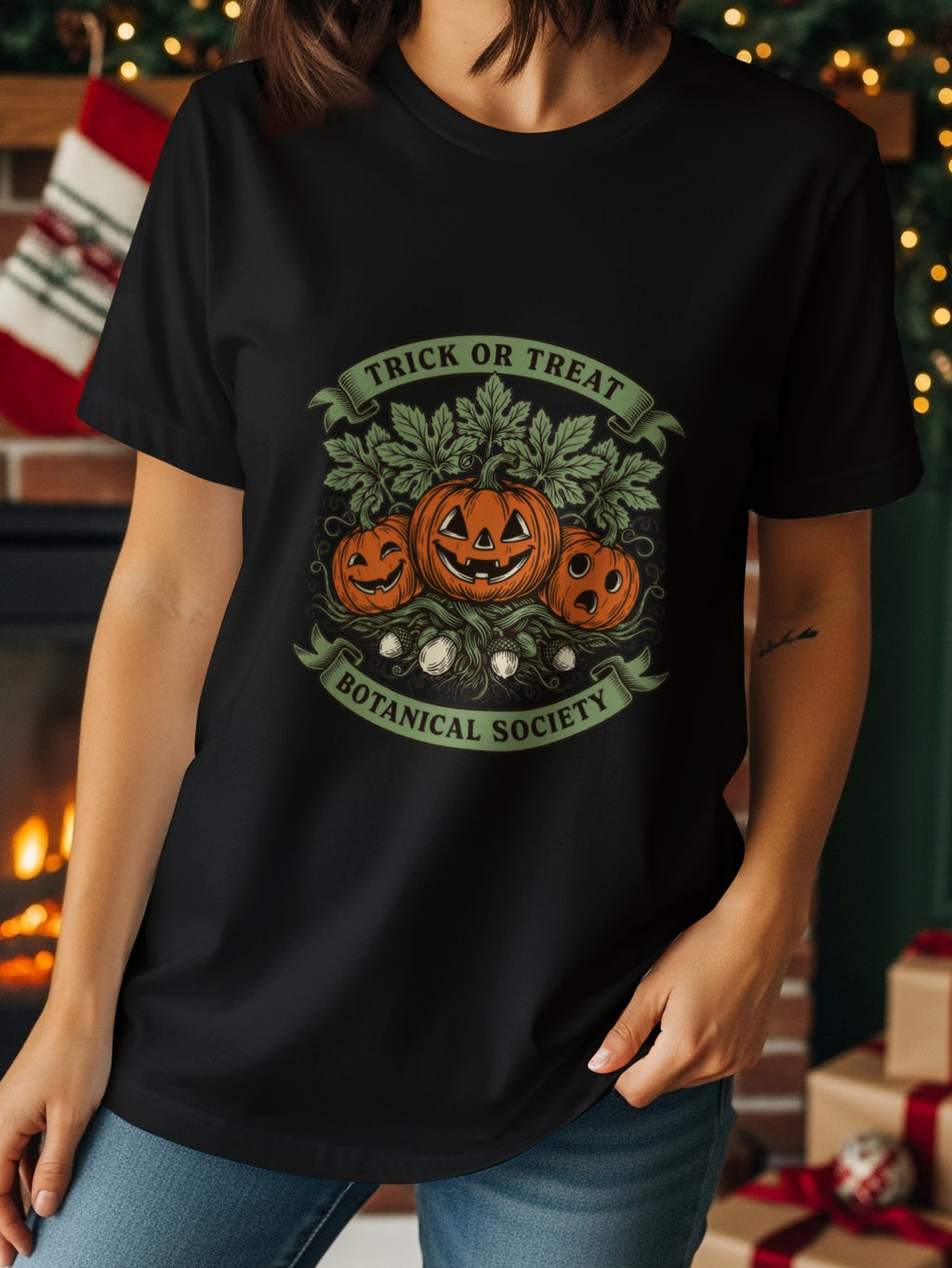 Black t-shirt with Halloween pumpkins, leaves, acorns, and text "Trick or Treat Botanical Society."