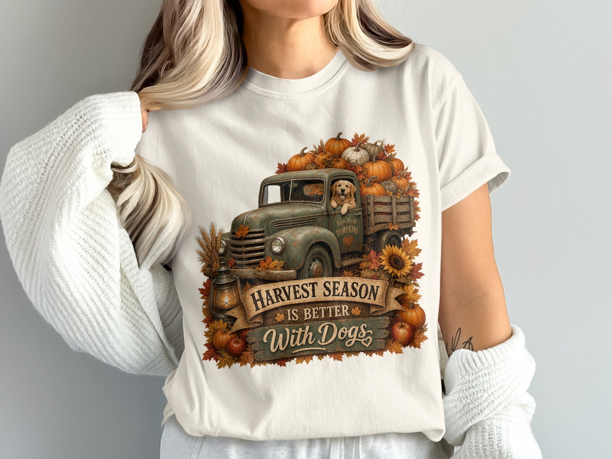 T-shirt graphic of vintage truck overflowing with pumpkins and a dog, reads "Harvest Season Is Better With Dogs".