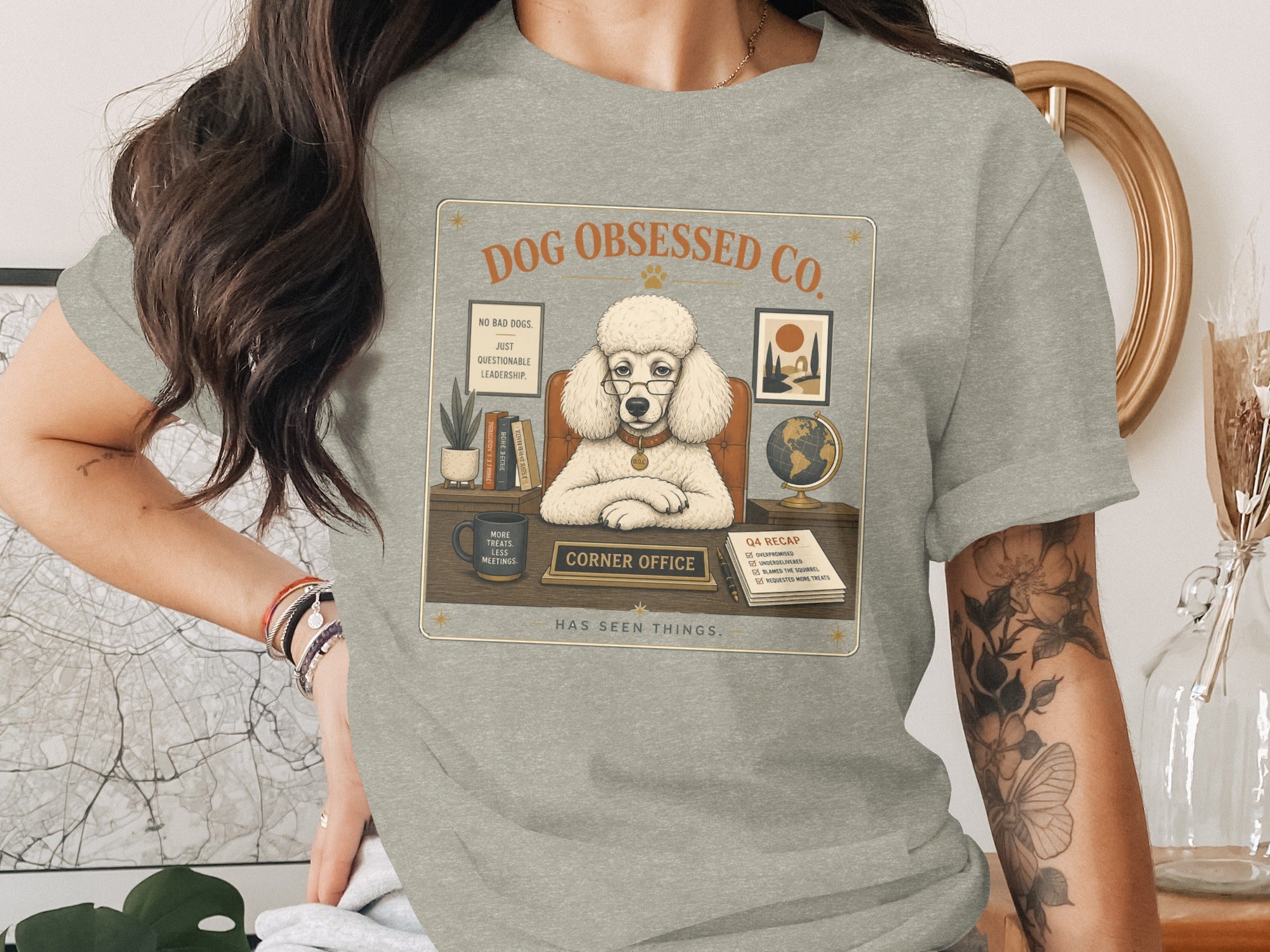 Poodle in glasses at a desk with "Corner Office" sign and Q4 recap.