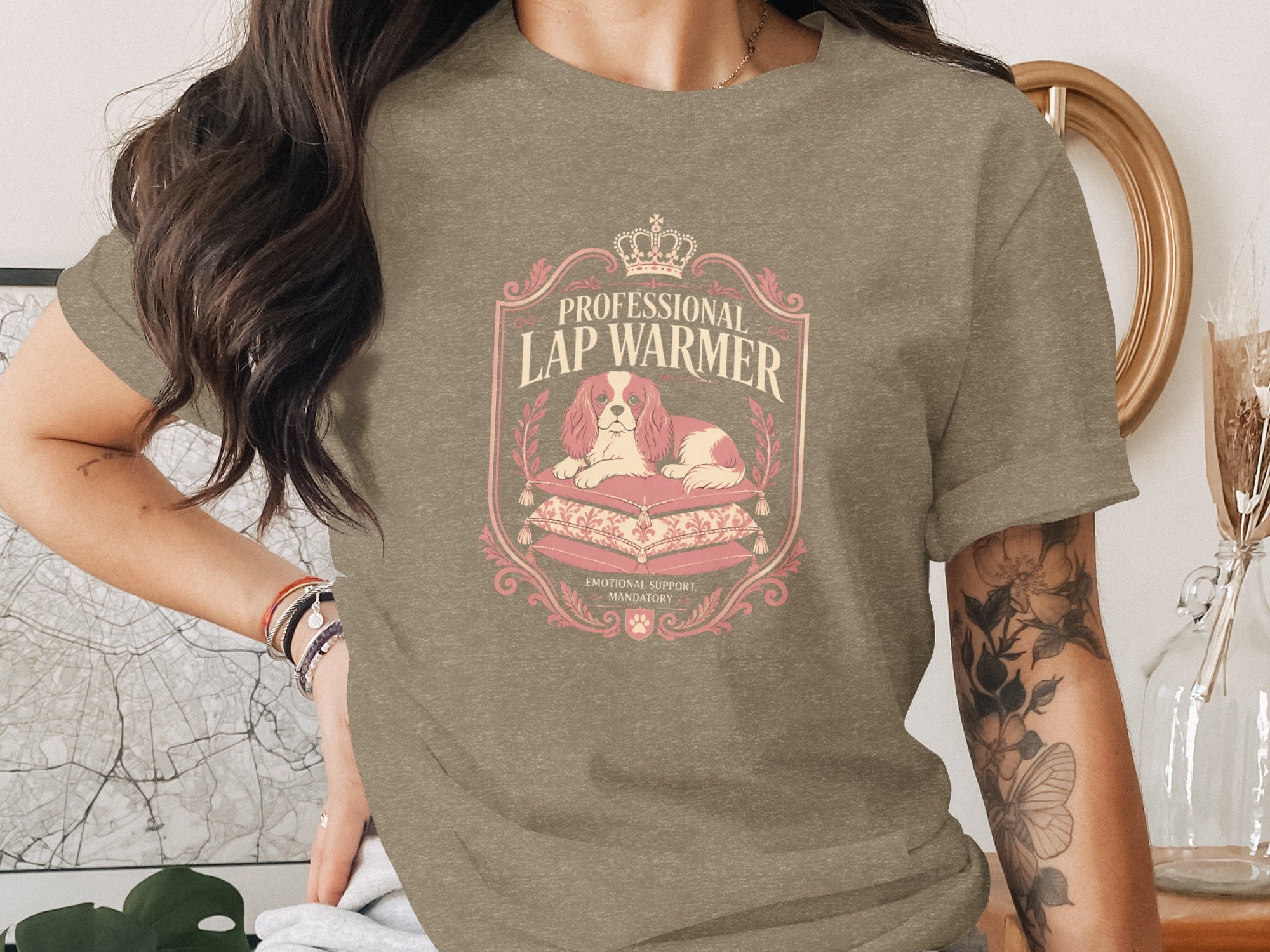T-shirt graphic with a dog atop pillows, reading "Professional Lap Warmer."