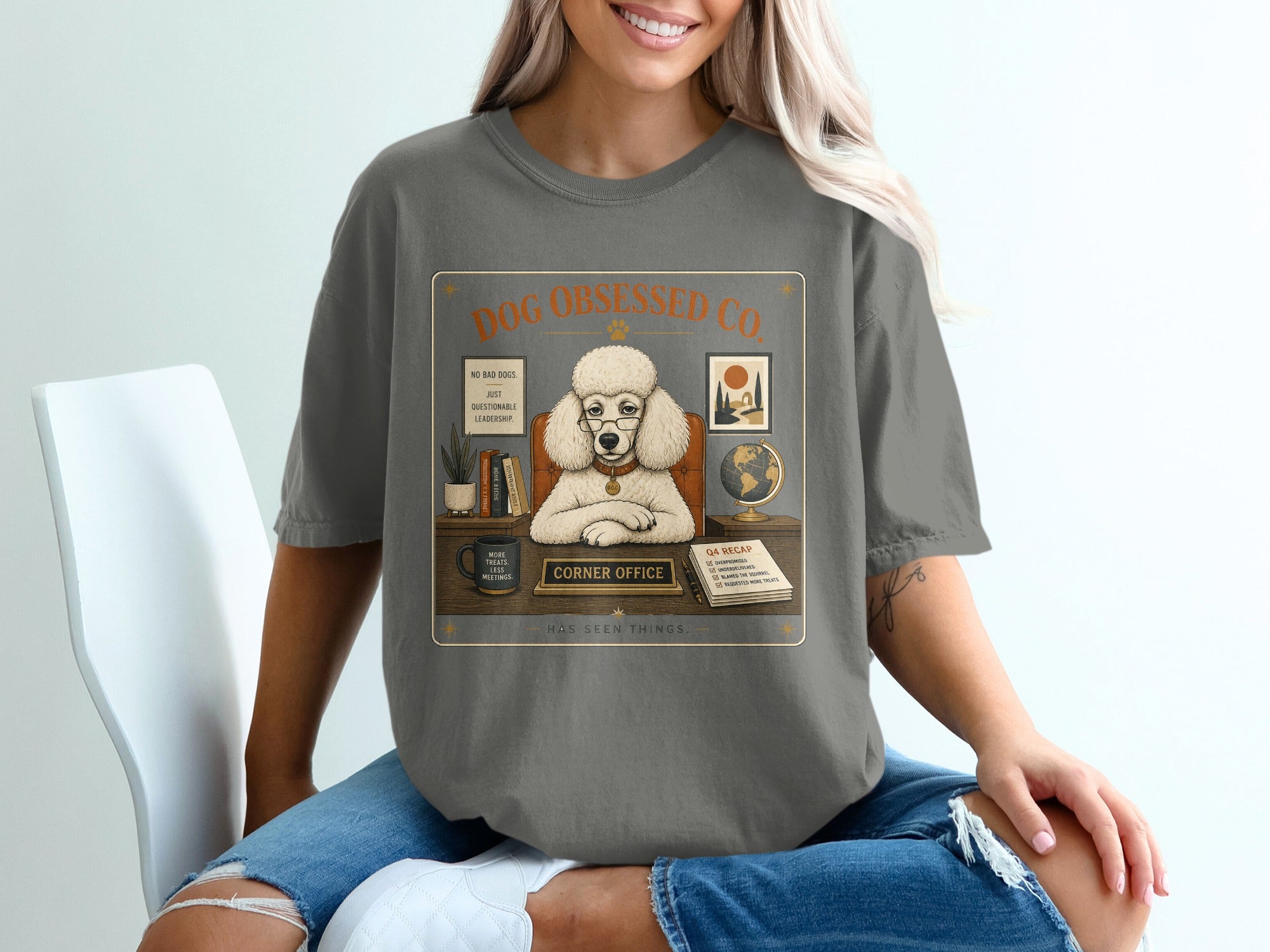 Poodle in glasses with text "Dog Obsessed Co." and "Corner Office" in a desk illustration.
