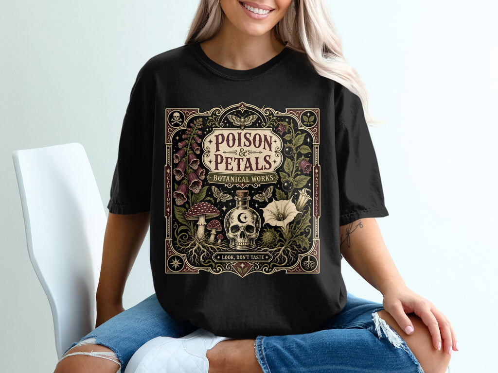 Black t-shirt with "POISON PETALS BOTANICAL WORKS" and mystical botanical design.