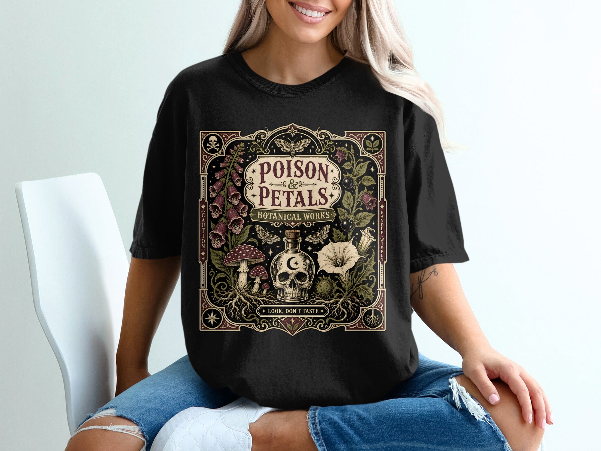 Black t-shirt with "POISON PETALS BOTANICAL WORKS" and mystical botanical design.