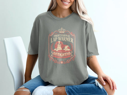 T-shirt featuring a Cavalier King Charles Spaniel on pillows with text "Professional Lap Warmer".