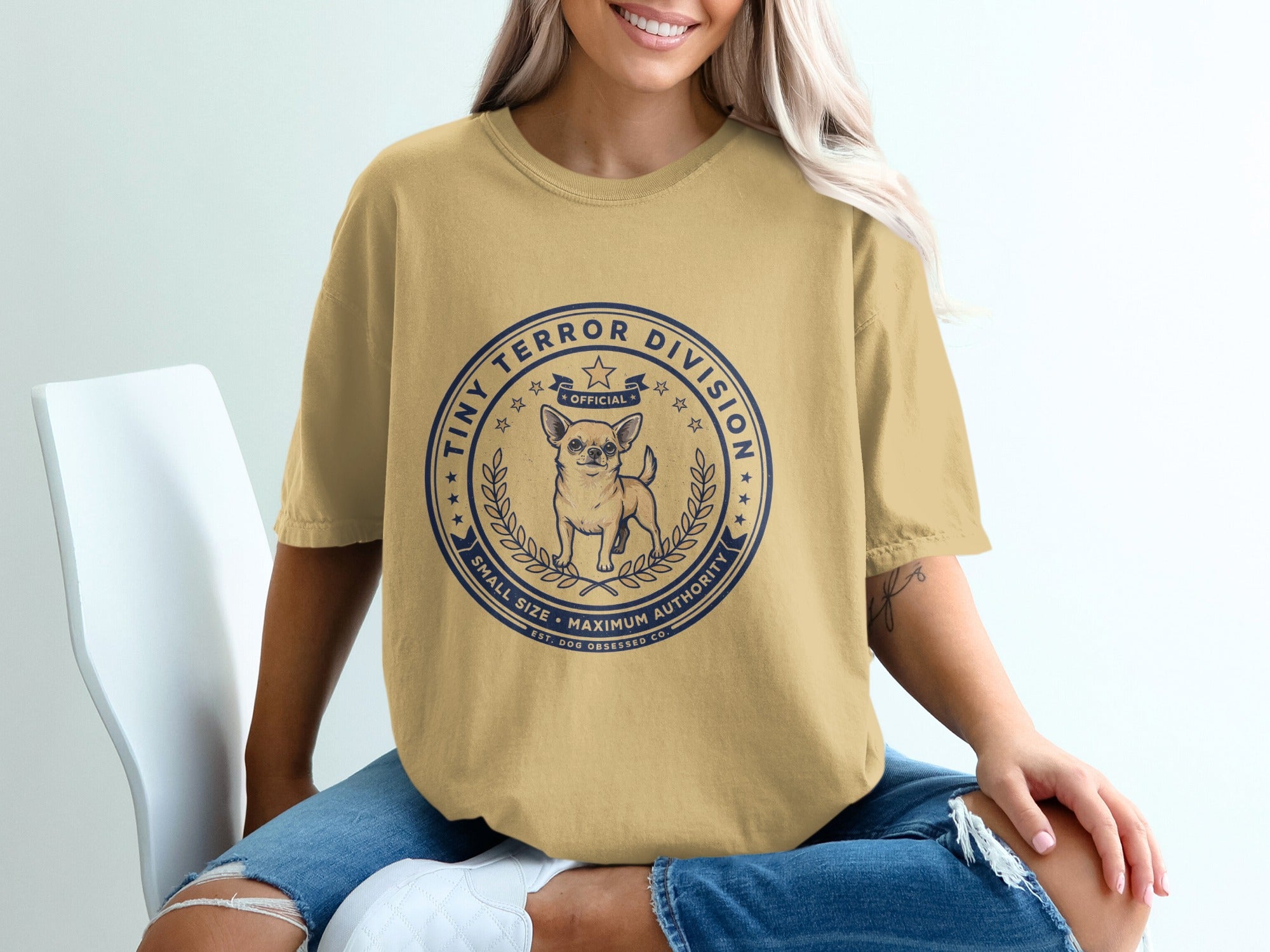 Yellow t-shirt with a round navy print featuring a chihuahua and "Tiny Terror Division" text.
