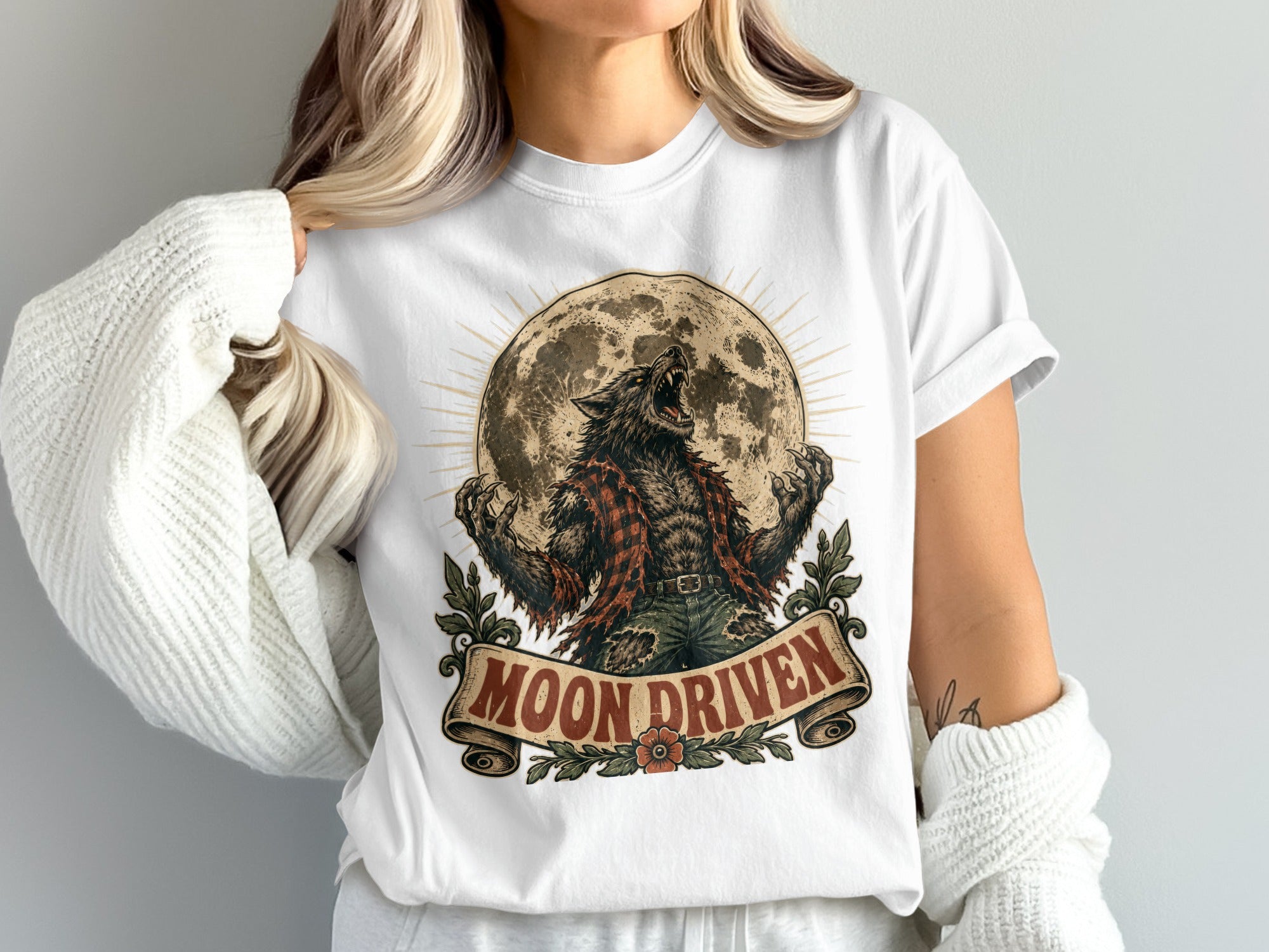 Werewolf howling at full moon graphic with "Moon Driven" text on a white t-shirt.