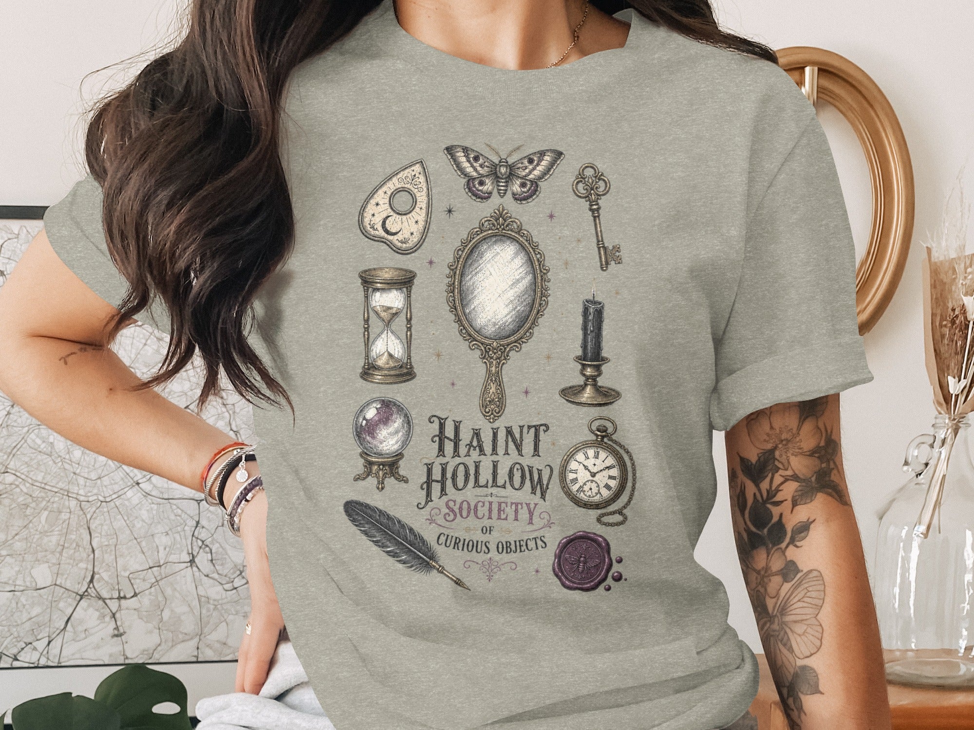 Haunt Hollow Society of Curious Objects graphic on light grey t-shirt.