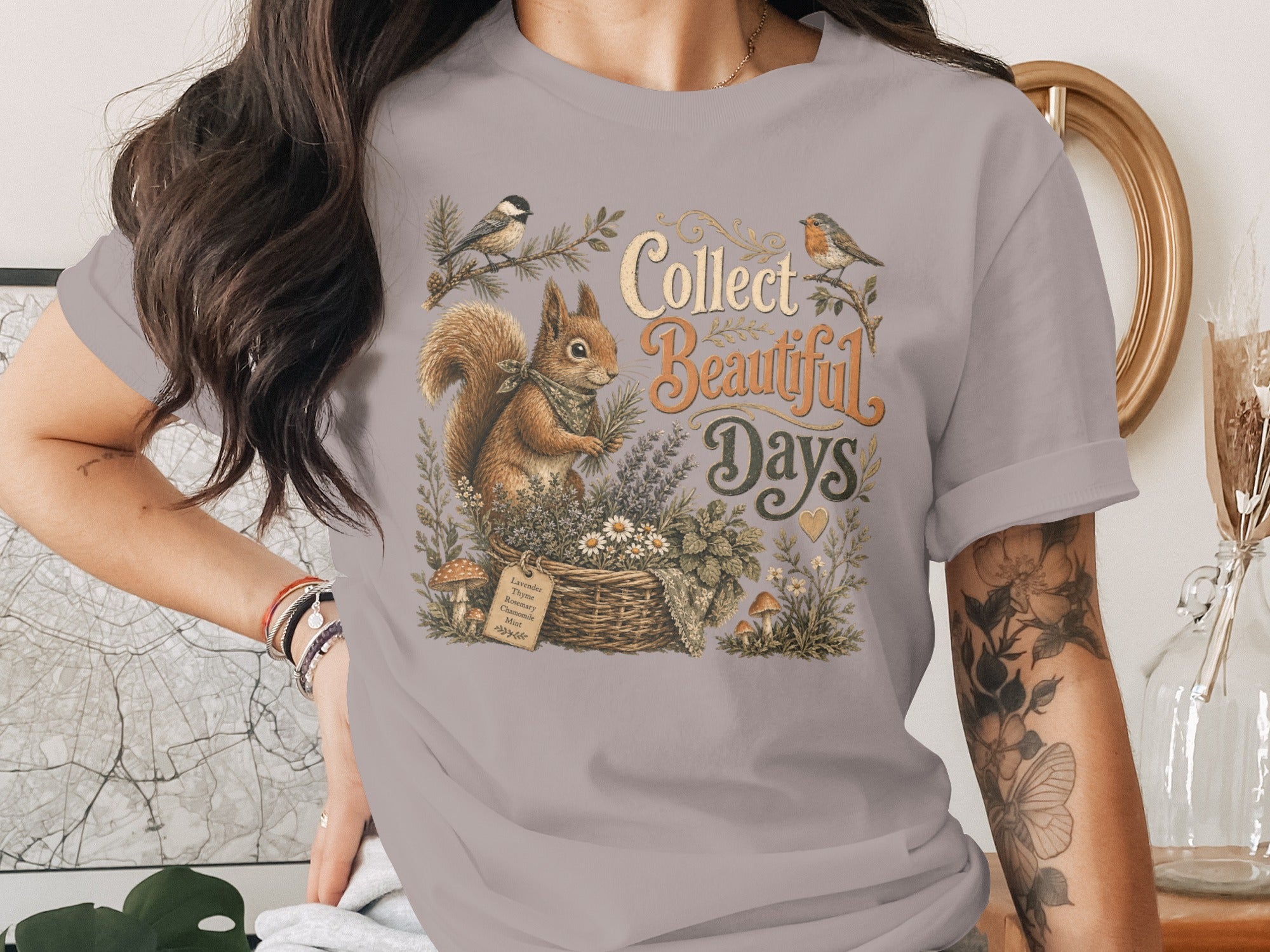 Squirrel with birds, flowers, mushrooms, and text "Collect Beautiful Days" on t-shirt.