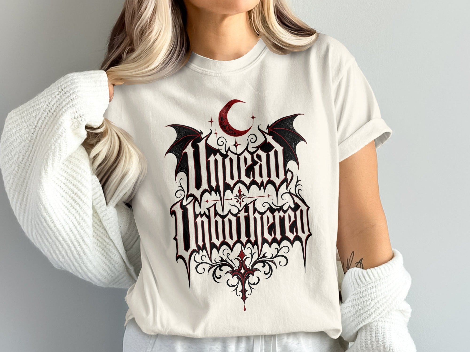 Cream t-shirt with gothic "Unchained" graphic and crescent moon.