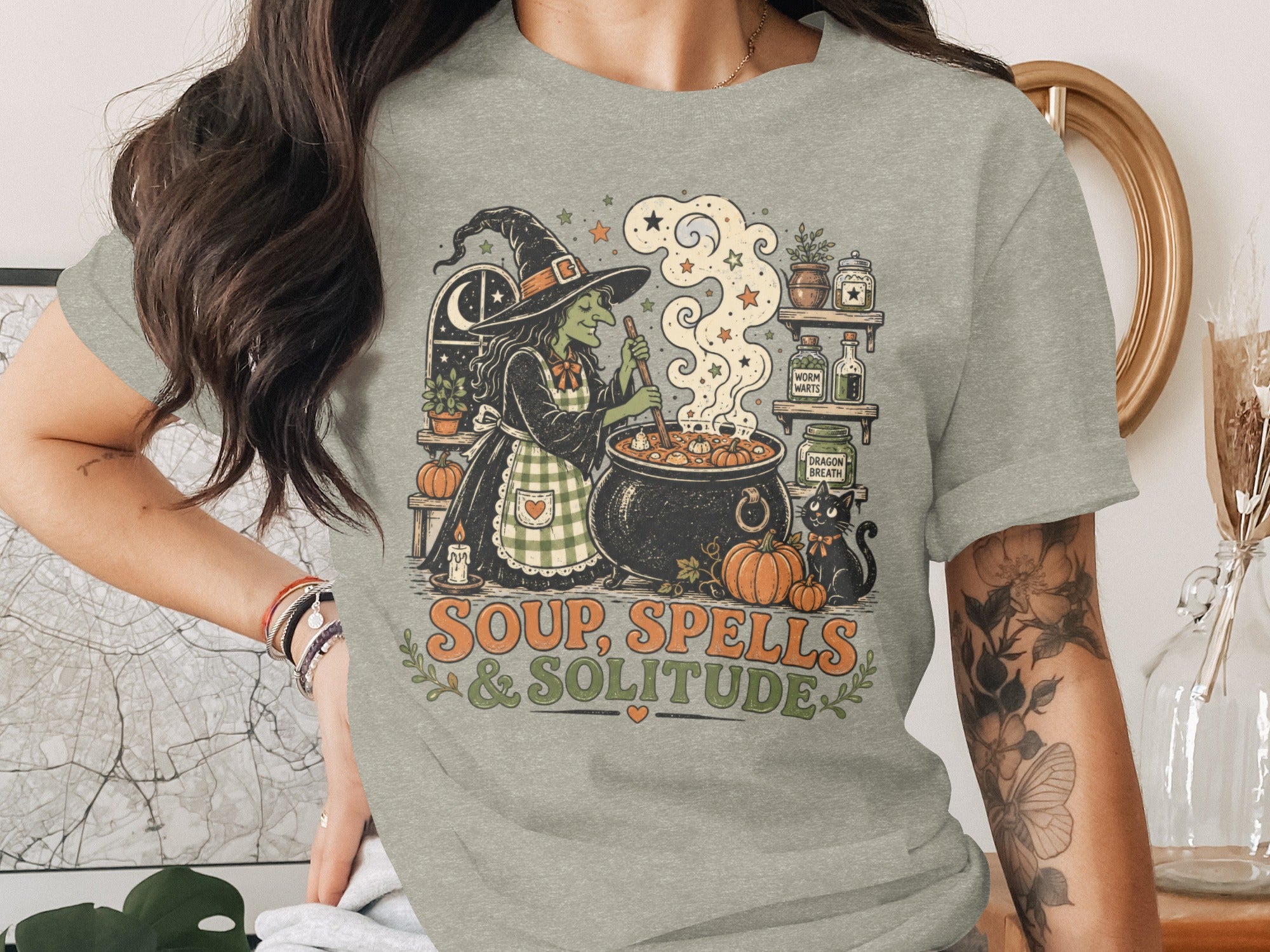 Witch making soup with cauldron, black cat, and text "Soup, Spells & Solitude".