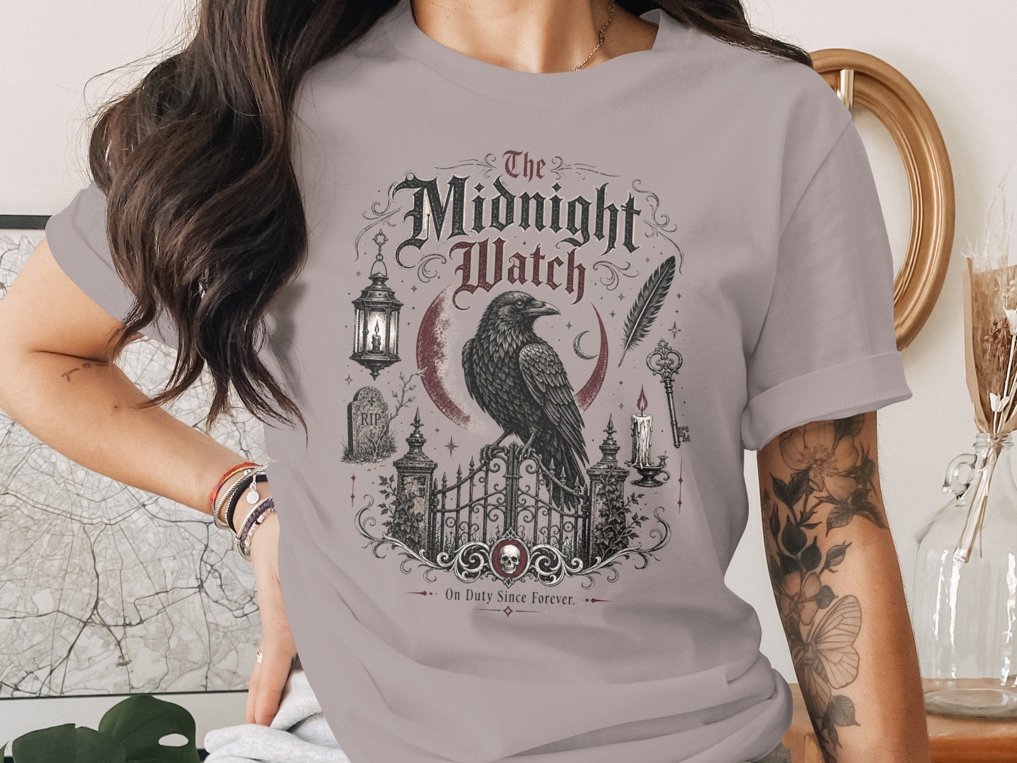 "The Midnight Watch" graphic t-shirt with raven, gate, and gothic motifs.