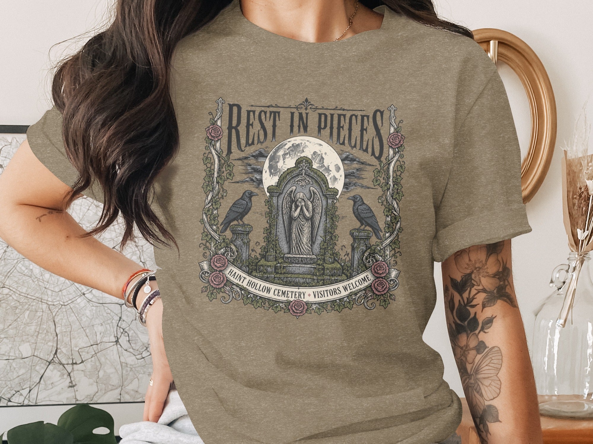 T-shirt with "Rest in Pieces" graphic of a tomb, moon, and ravens.