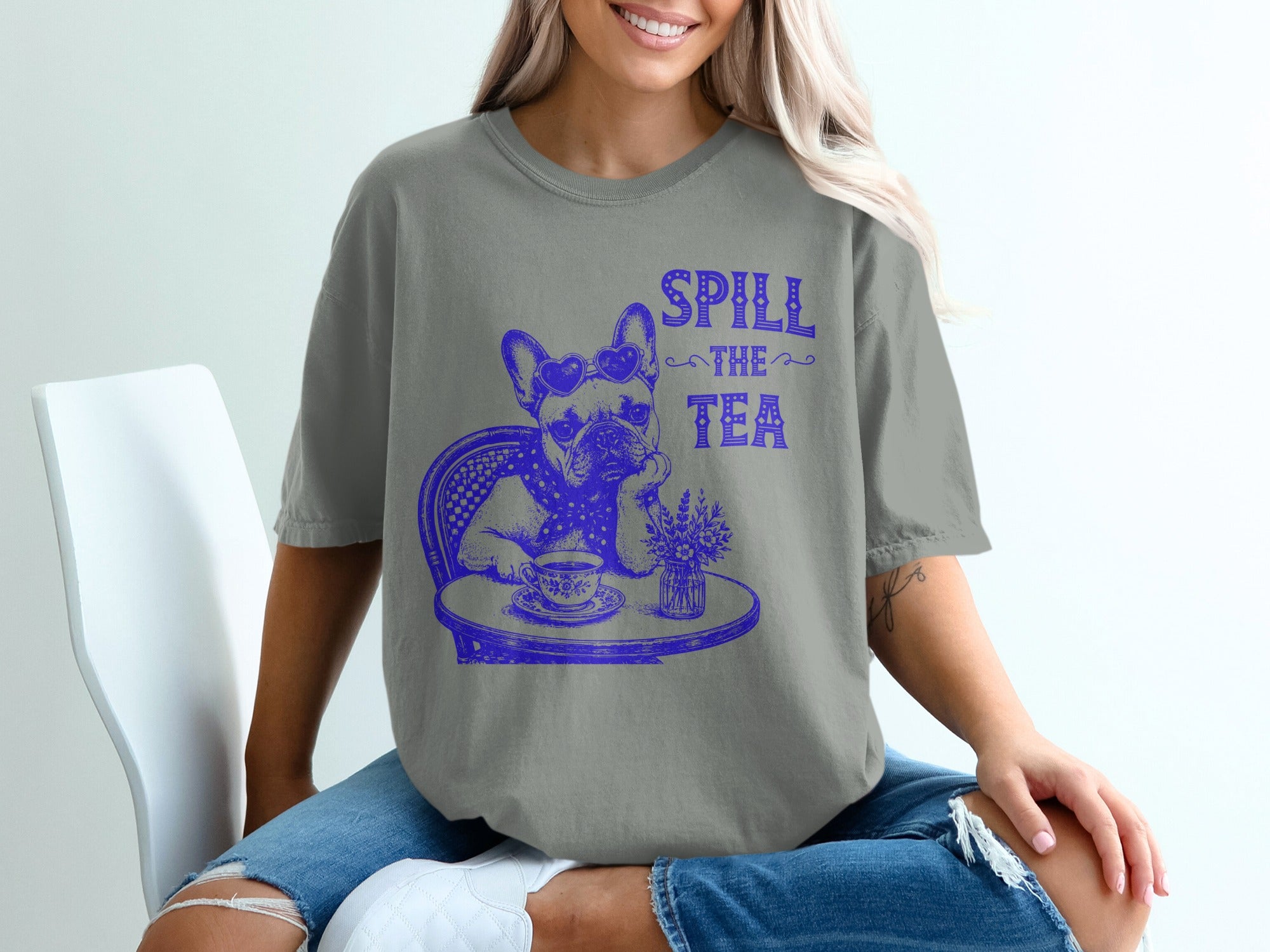 French bulldog with sunglasses wearing scarf, with text "SPILL THE TEA".