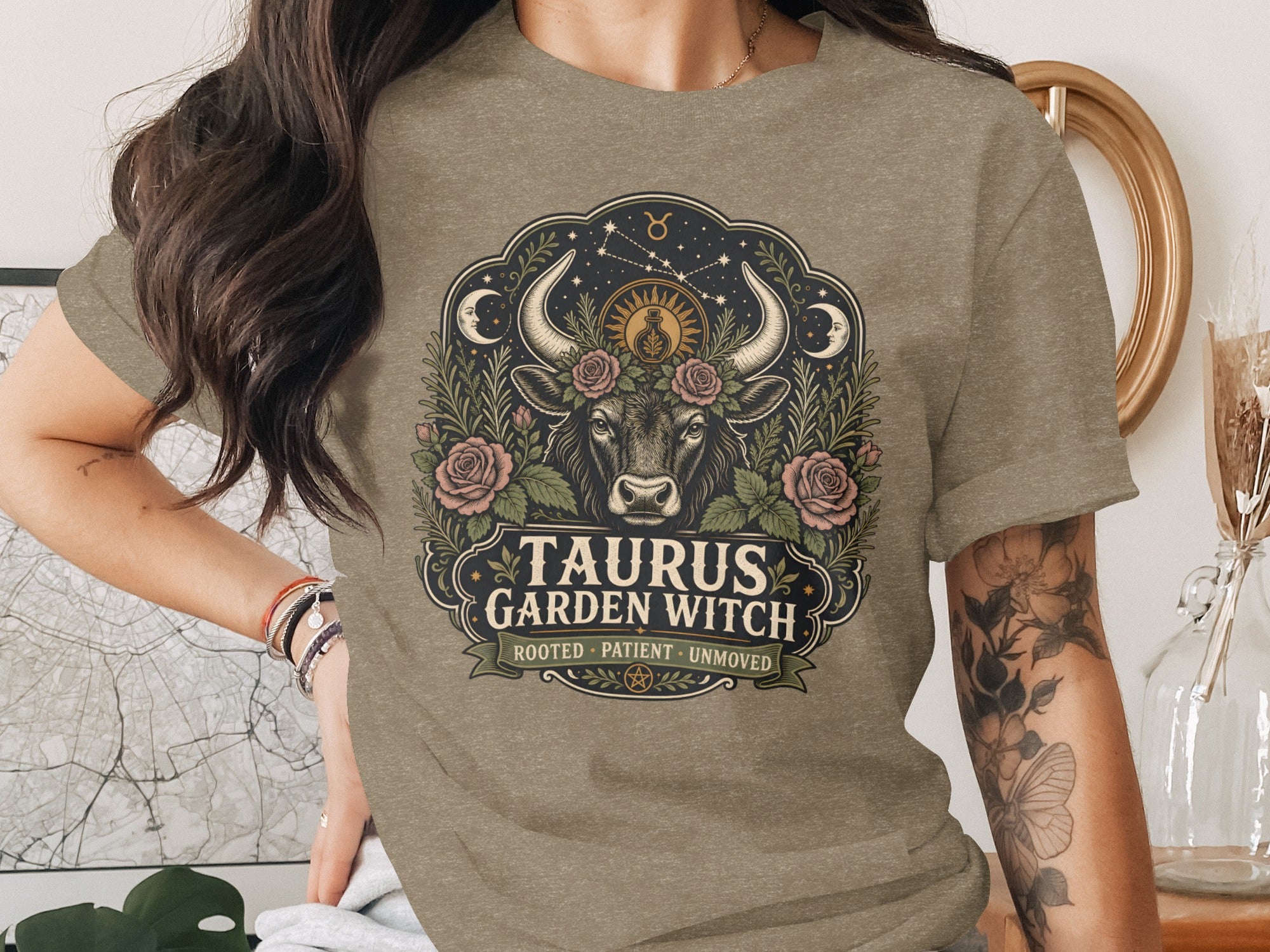 Taurus Garden Witch graphic on a taupe t-shirt featuring a bull, roses, moon, and stars.