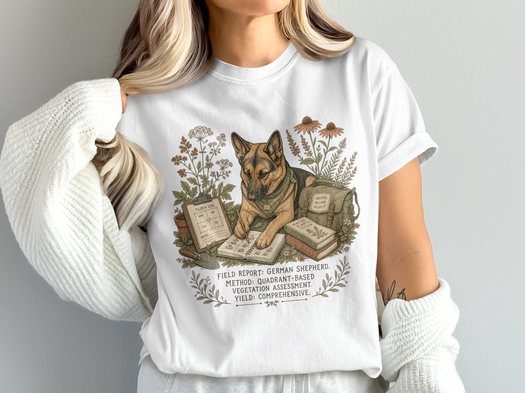 German Shepherd with gardening tools and flora log on a white t-shirt.