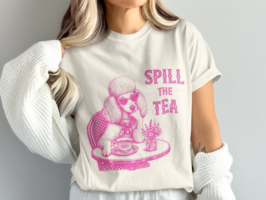 Pink poodle wearing sunglasses sits at a table drinking tea with "Spill the Tea" text.