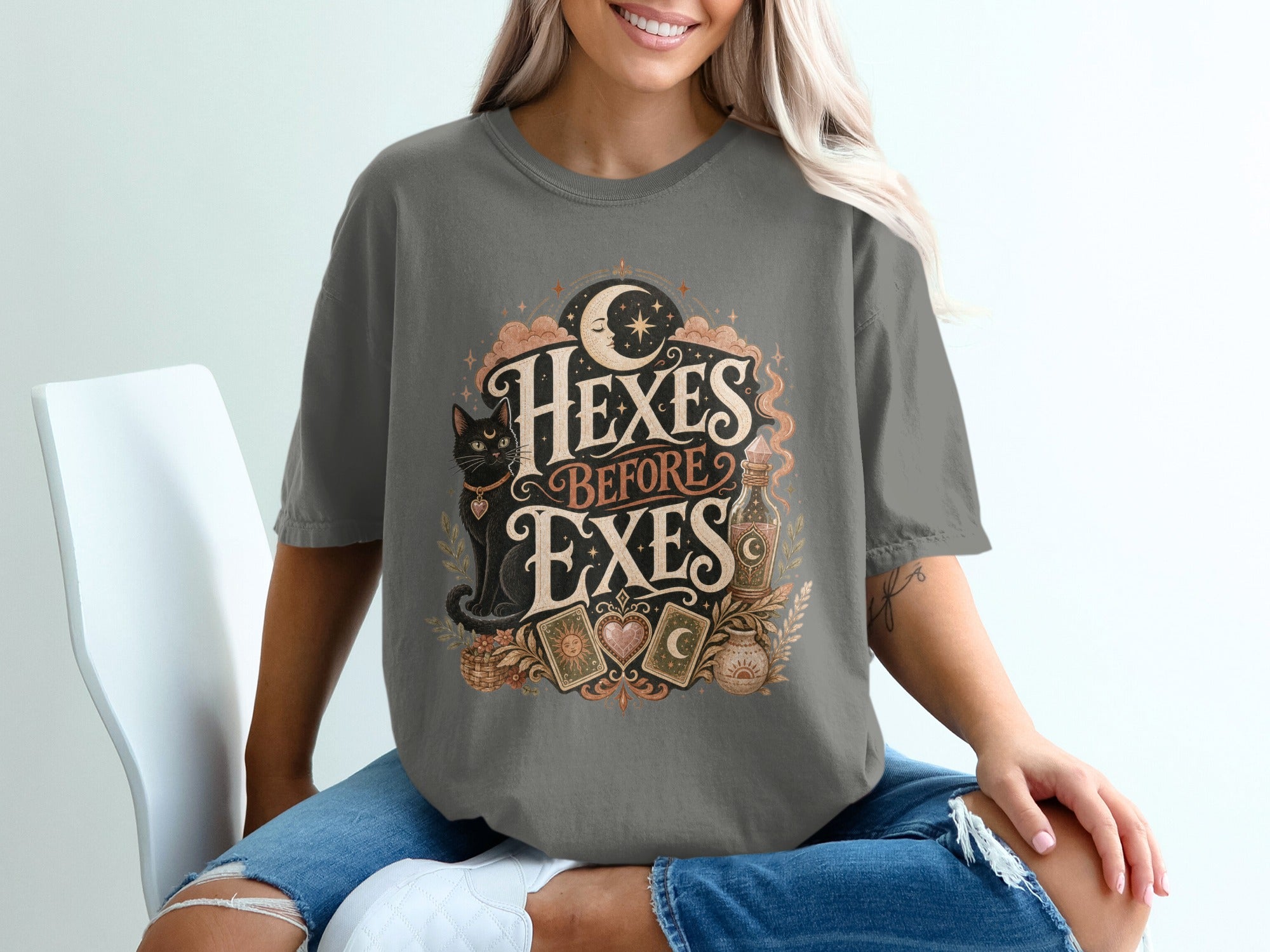T-shirt with "Hexes Before Exes" text, moon, cat, tarot cards, and potion bottle.