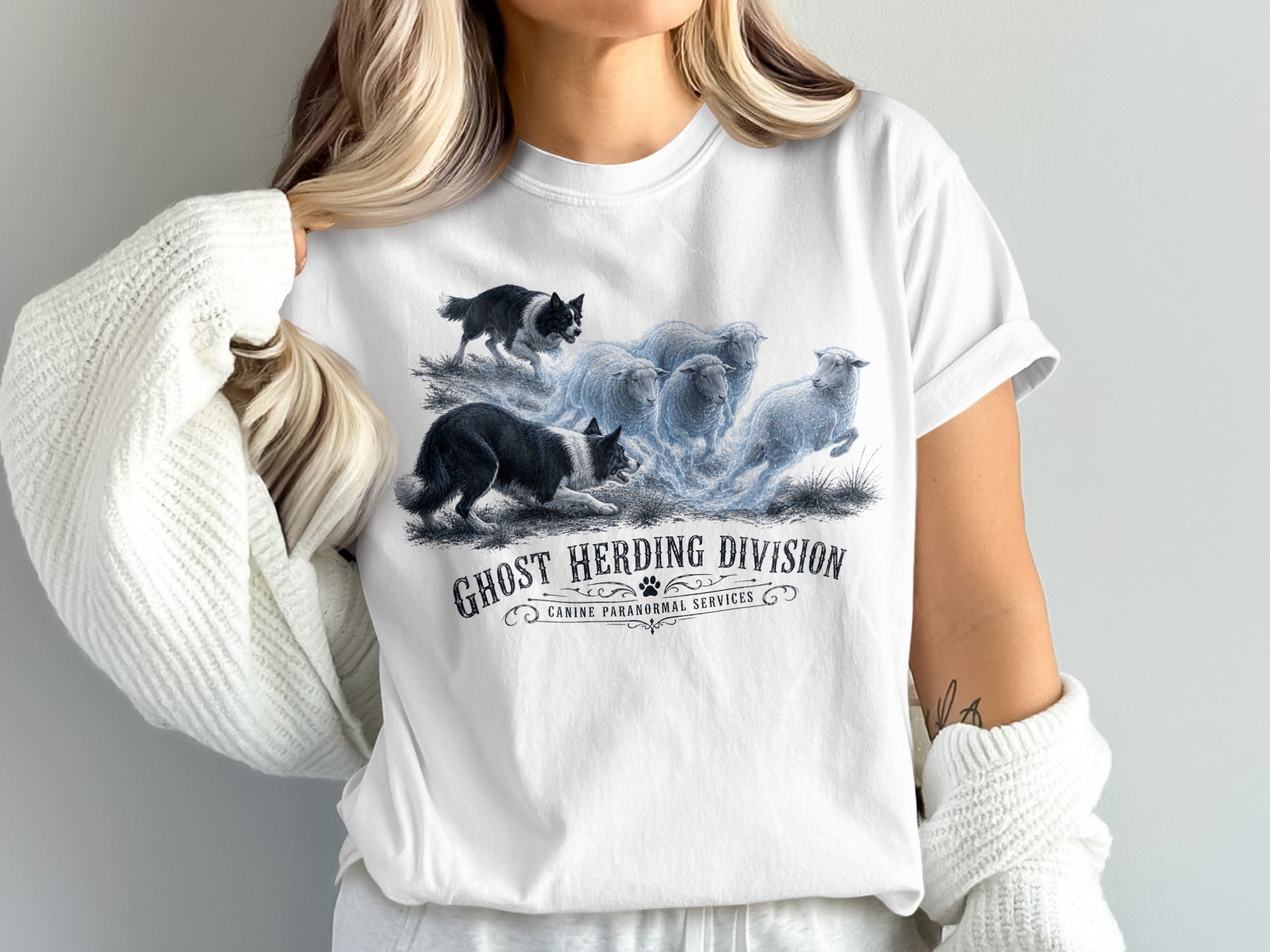 White t-shirt with spooky dogs herding glowing sheep and "Ghost Herding Division" text.
