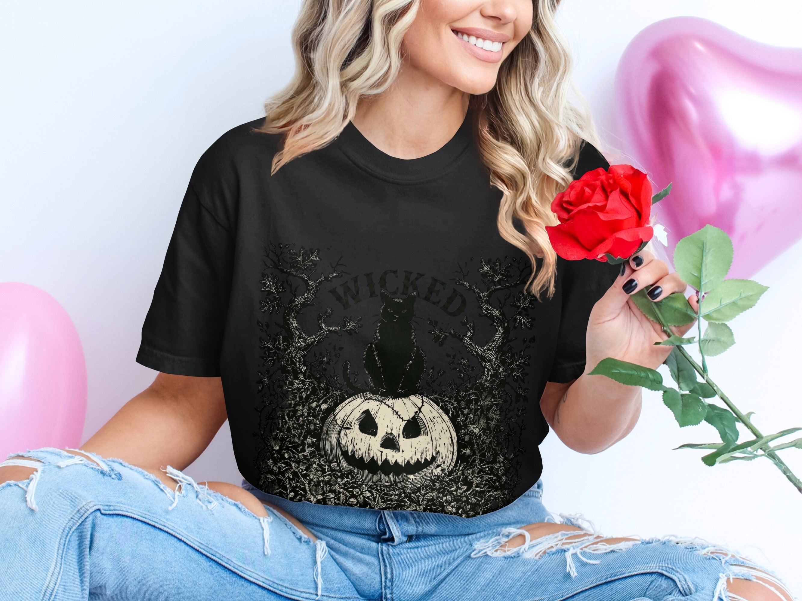 Black t-shirt with Wicked text, black cat, and jack-o'-lantern graphic.