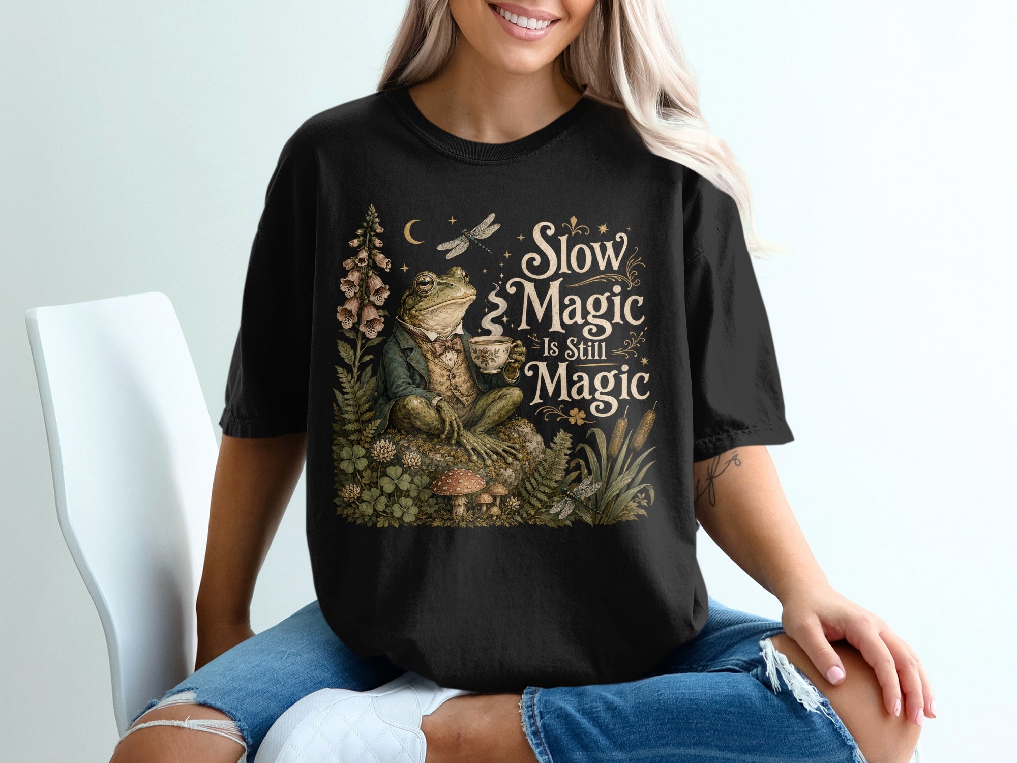 Frog in suit holding tea cup with text "Slow Magic Is Still Magic".