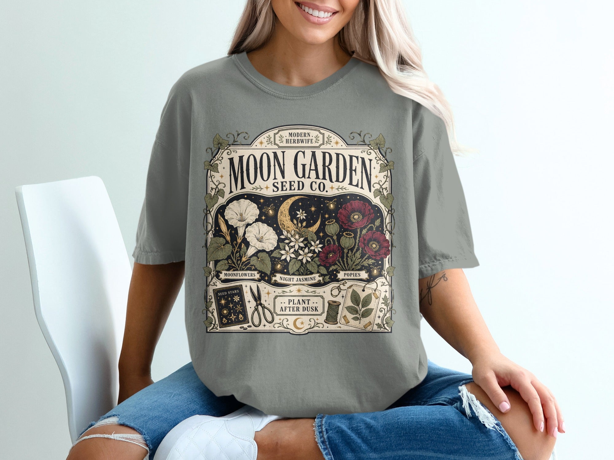 Gray t-shirt with "Moon Garden Seed Co." vintage floral design and plant labels.