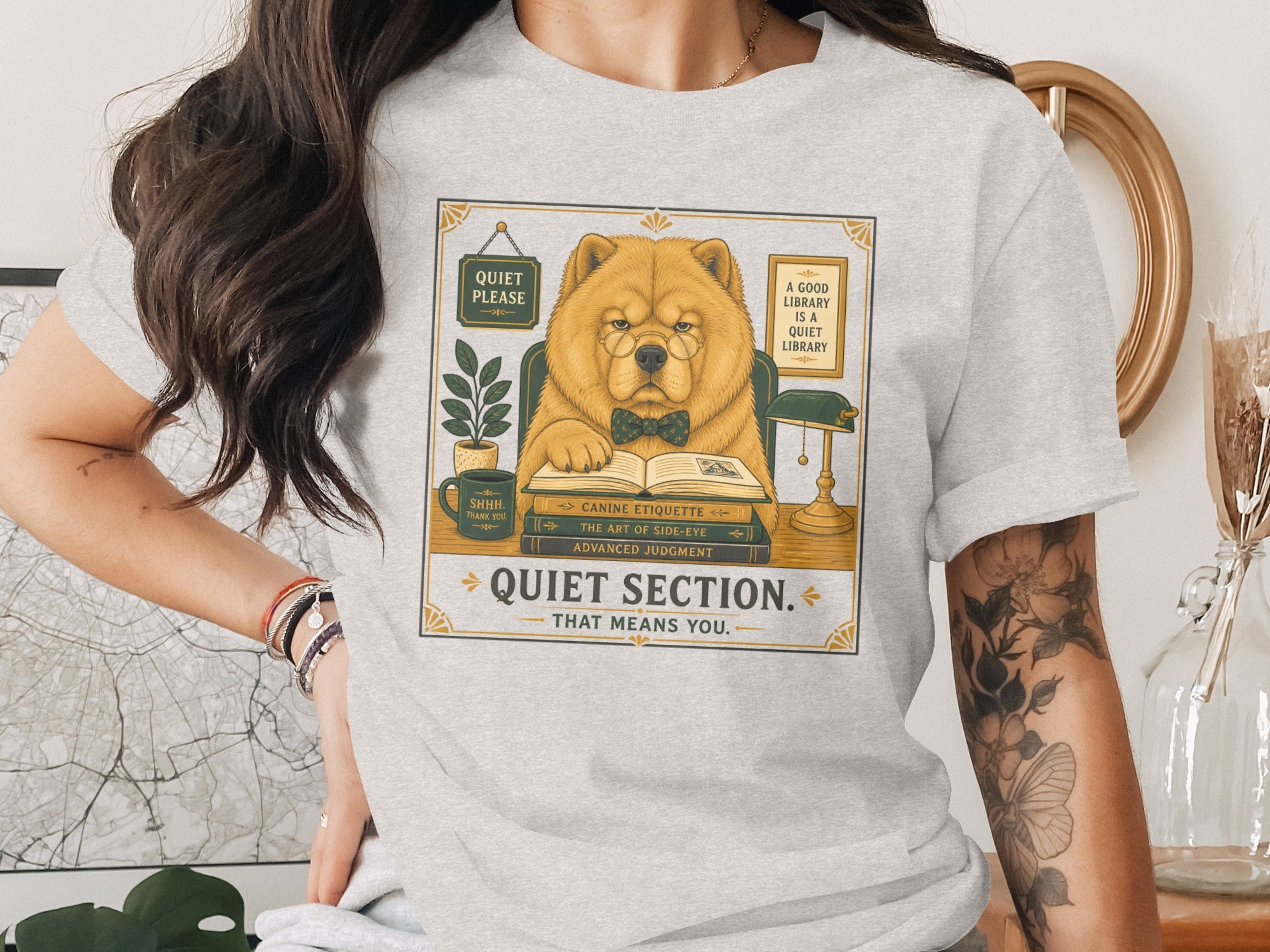 Chow chow dog wearing glasses and bowtie reading books with "Quiet Section" text.
