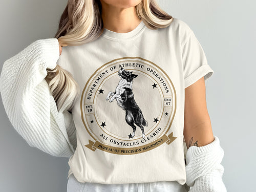 White t-shirt with a dog jumping and text: Department of Athletic Operations, Unit 87, Est. 19.