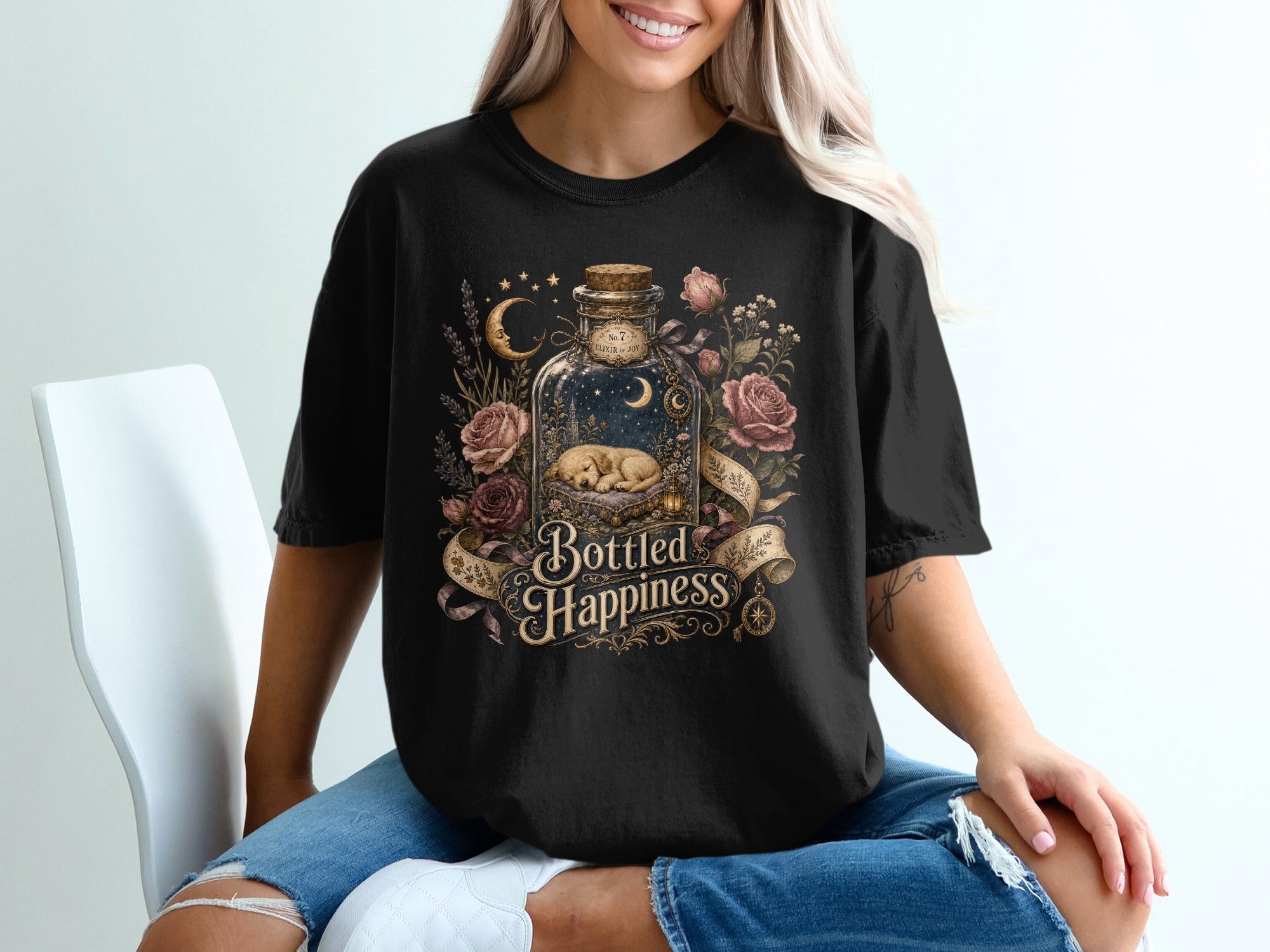 Black t-shirt with "Bottled Happiness" design featuring a sleeping puppy in a bottle.