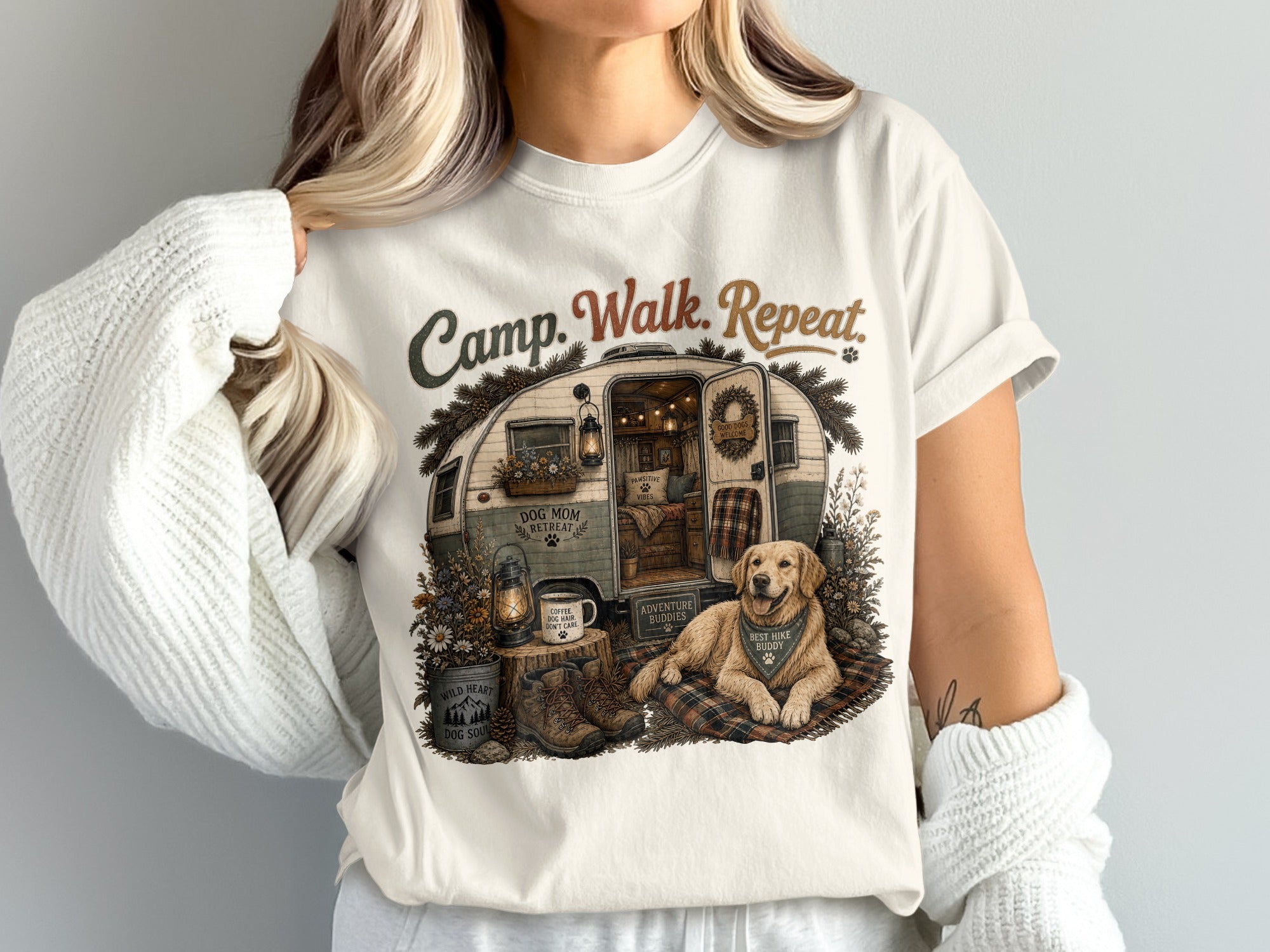 T-shirt graphic with a vintage camper, golden retriever, boots, and text "Camp. Walk. Repeat."
