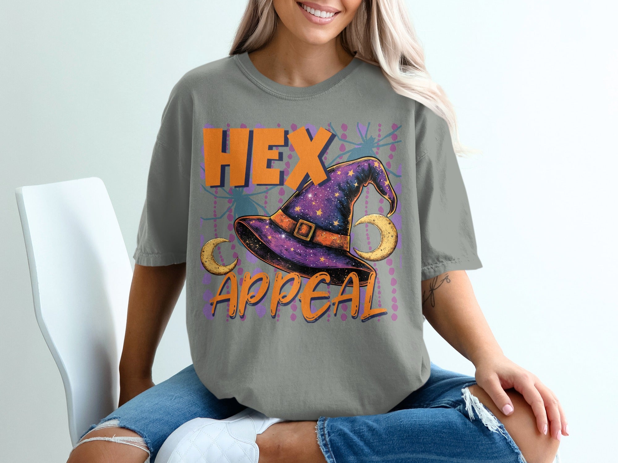 Gray t-shirt with "HEX APPEAL" text, a witch's hat, moons, and spiders.
