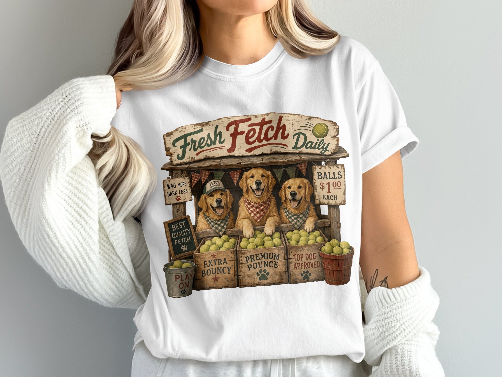 Three Golden Retrievers behind a stall labeled "Fresh Fetch Daily" selling balls.